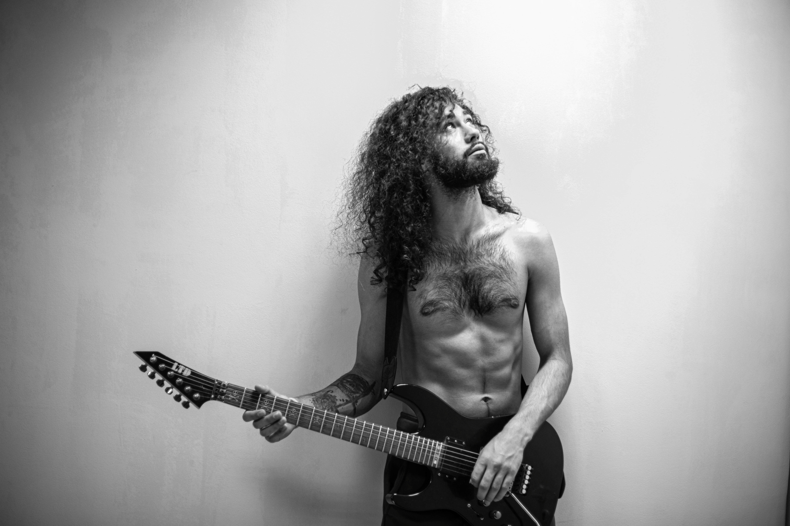 Черно-белый мужской портрет гитариста с гитарой 