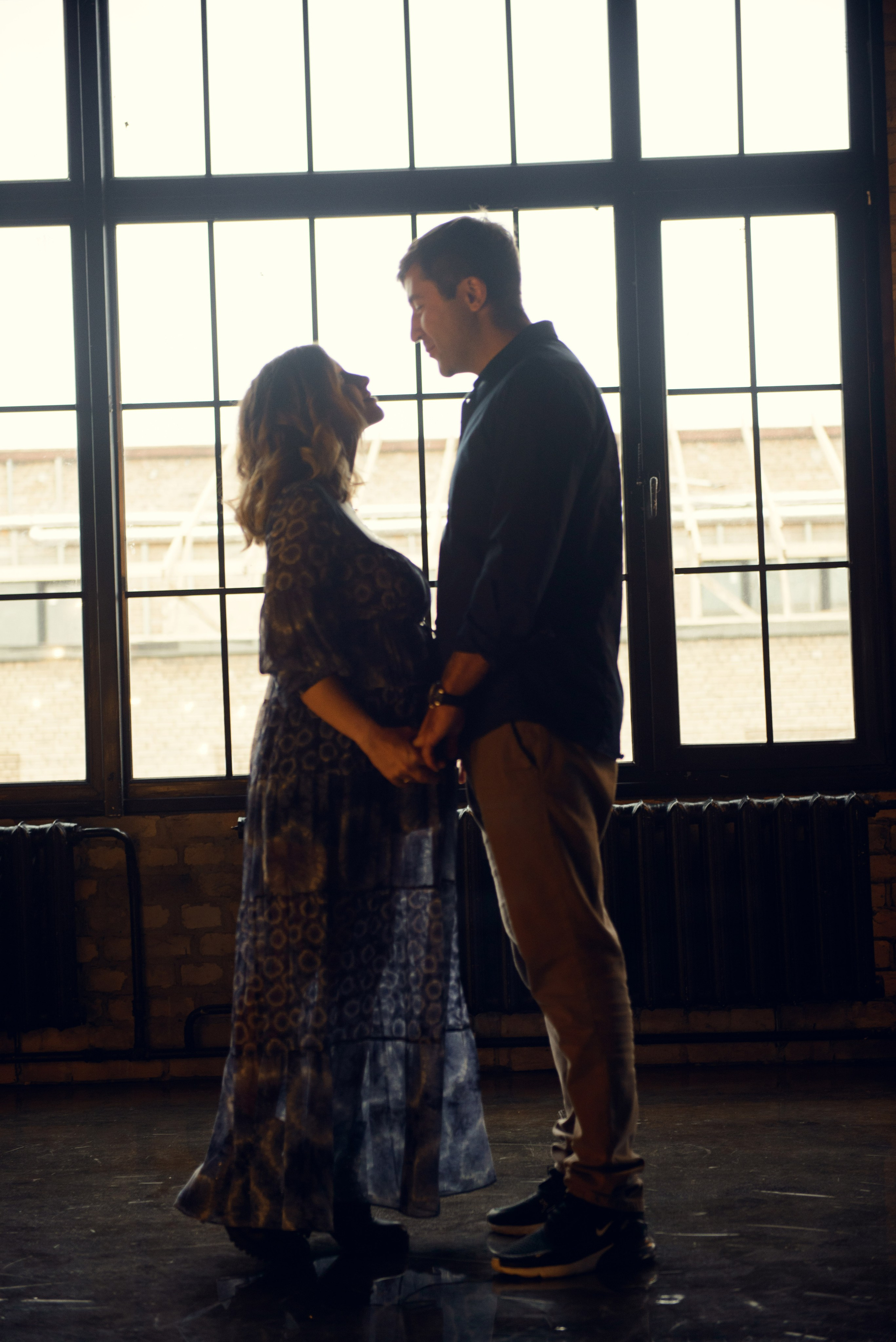 Family photo shoot with a pregnant woman in a loft studio, 