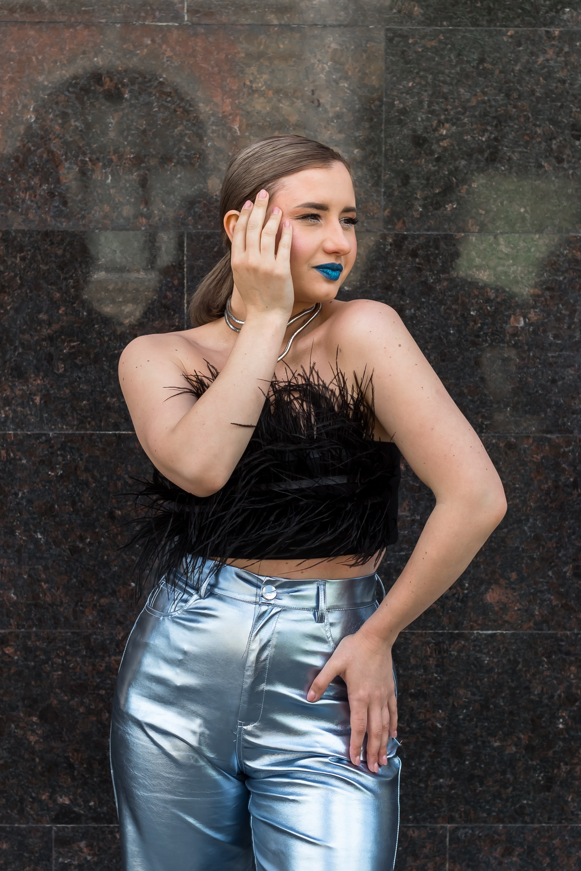 На фотографии девушка стоит, рука на бедре.