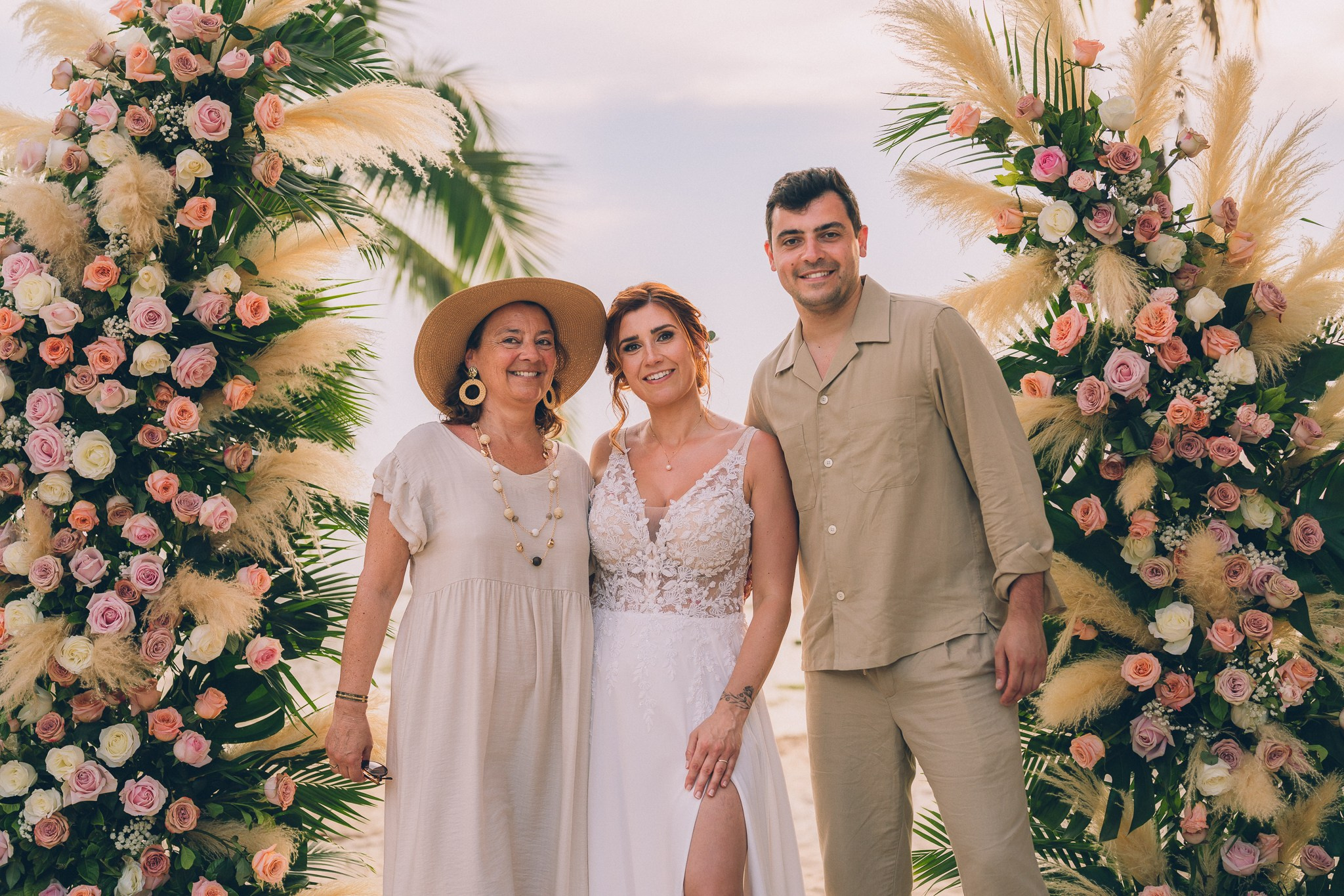 Wedding celebration with guests on a tropical sunset beach in Koh Samui