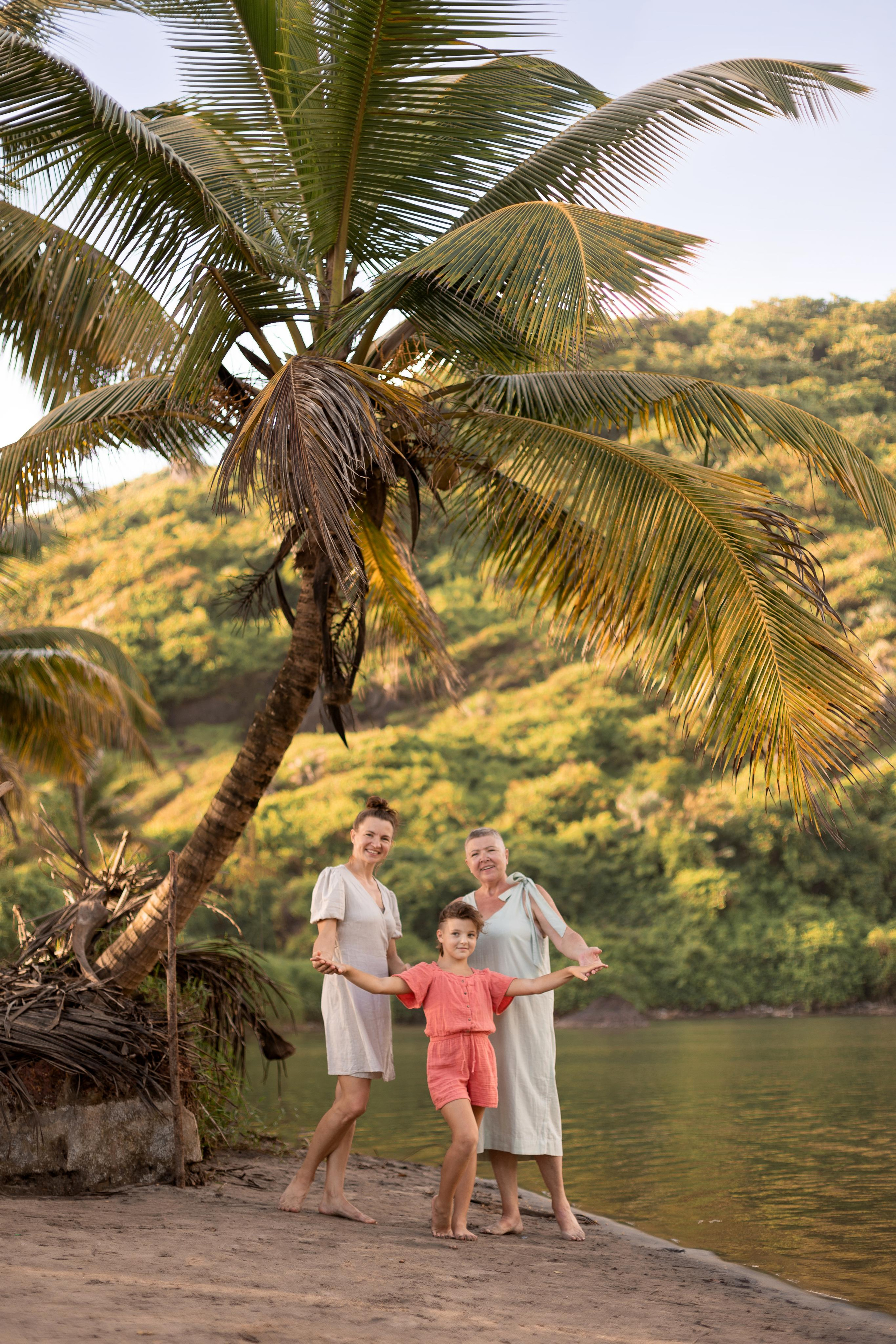 family standing under the palm tree in india