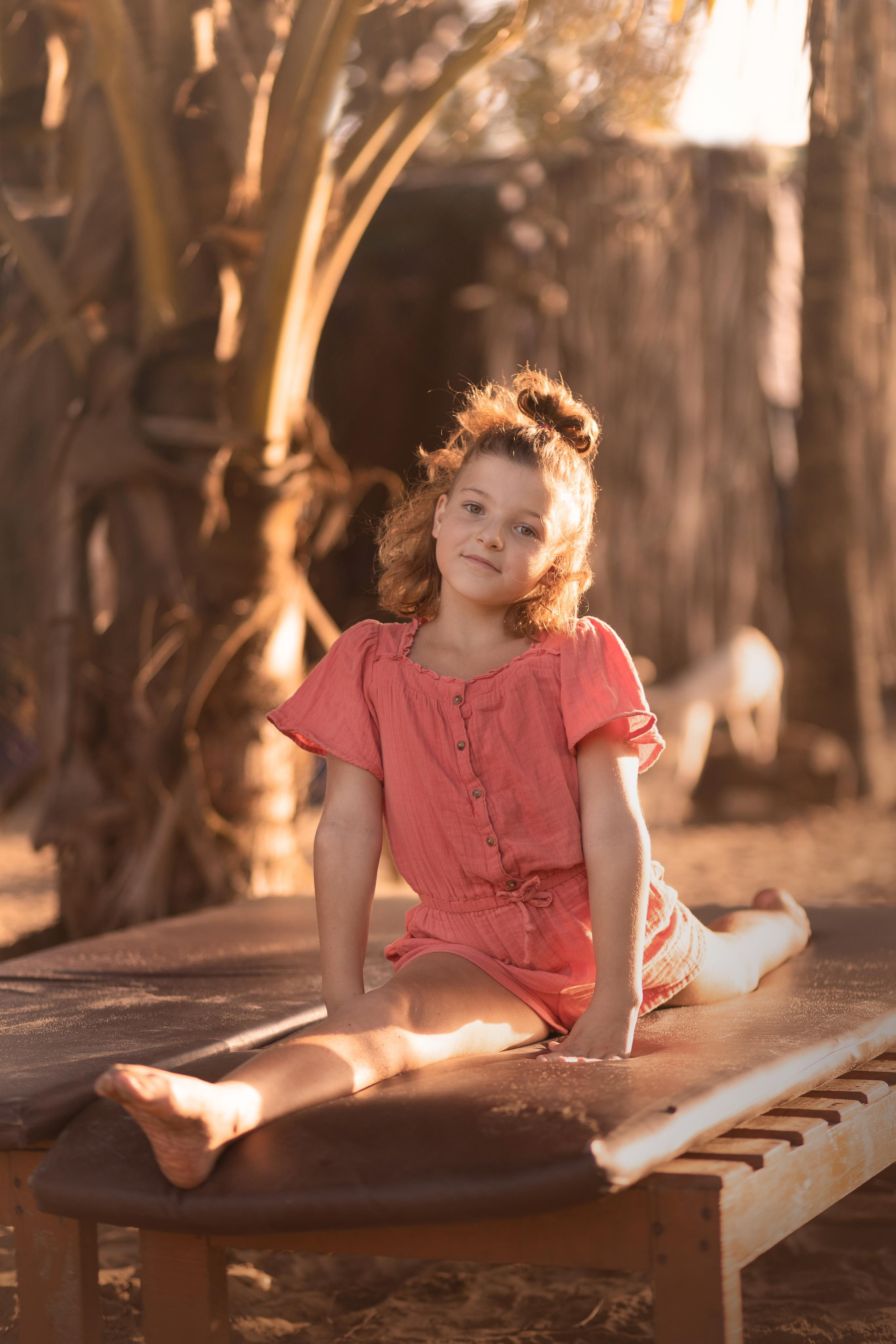 girl sitting on the beach, stretching
