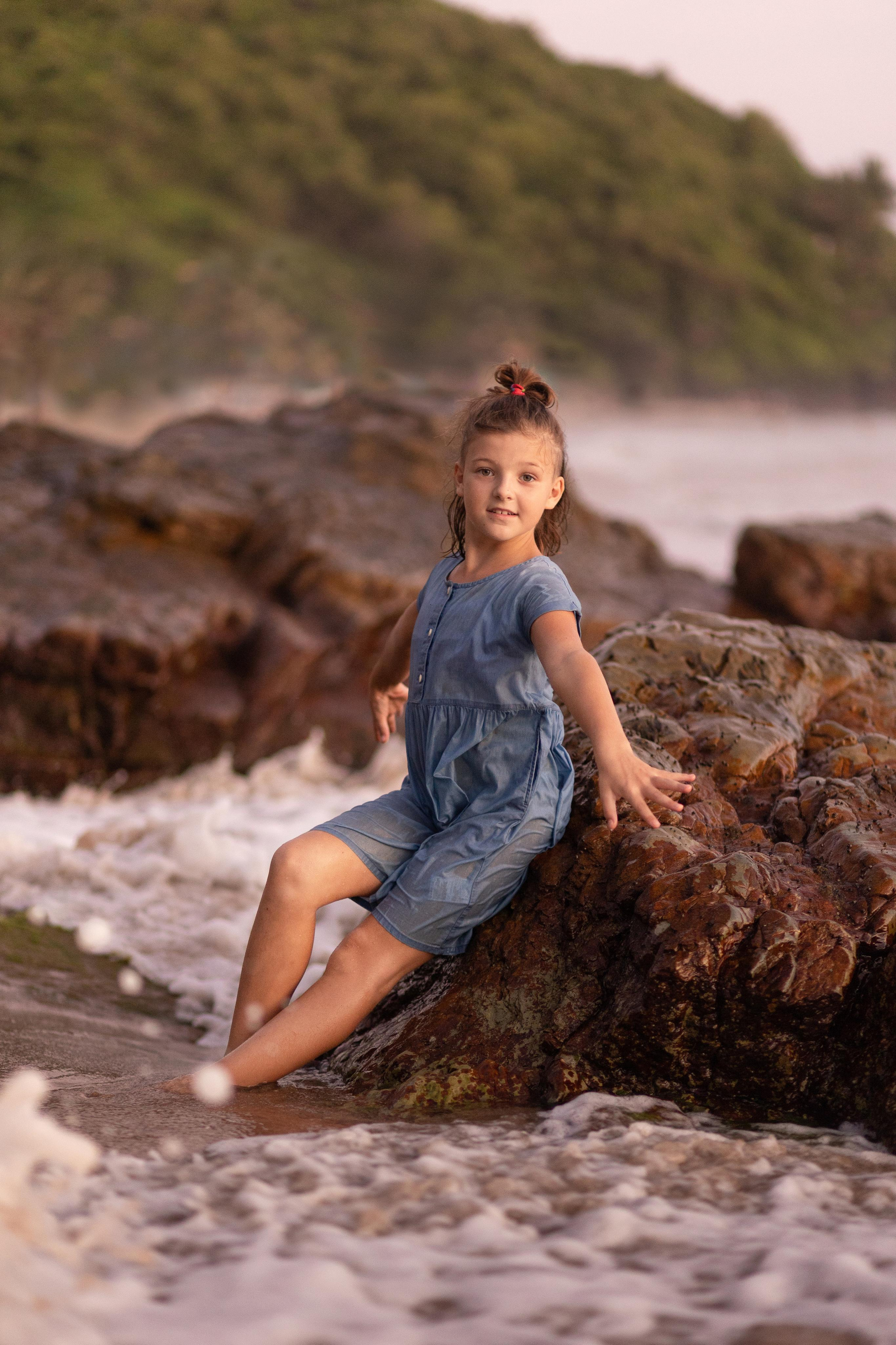 girl standing in the rocks in the ocean