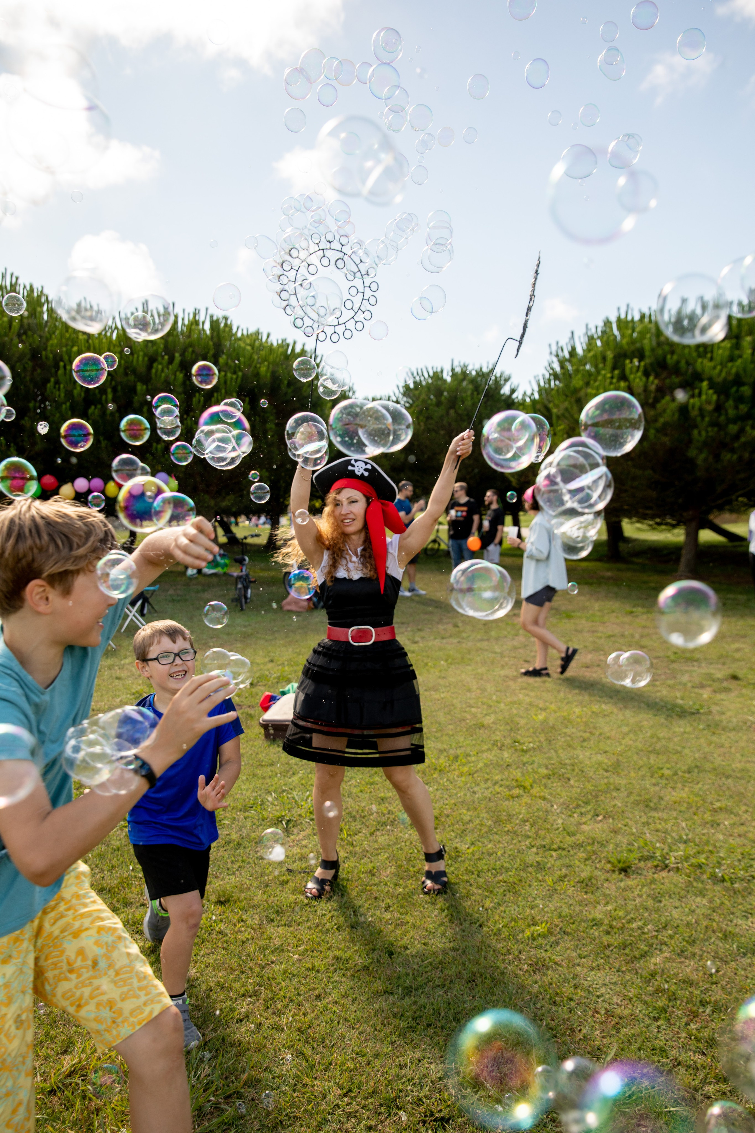 Kids enjoying playtime and soap bubbles in the park. Birthday photo shoot