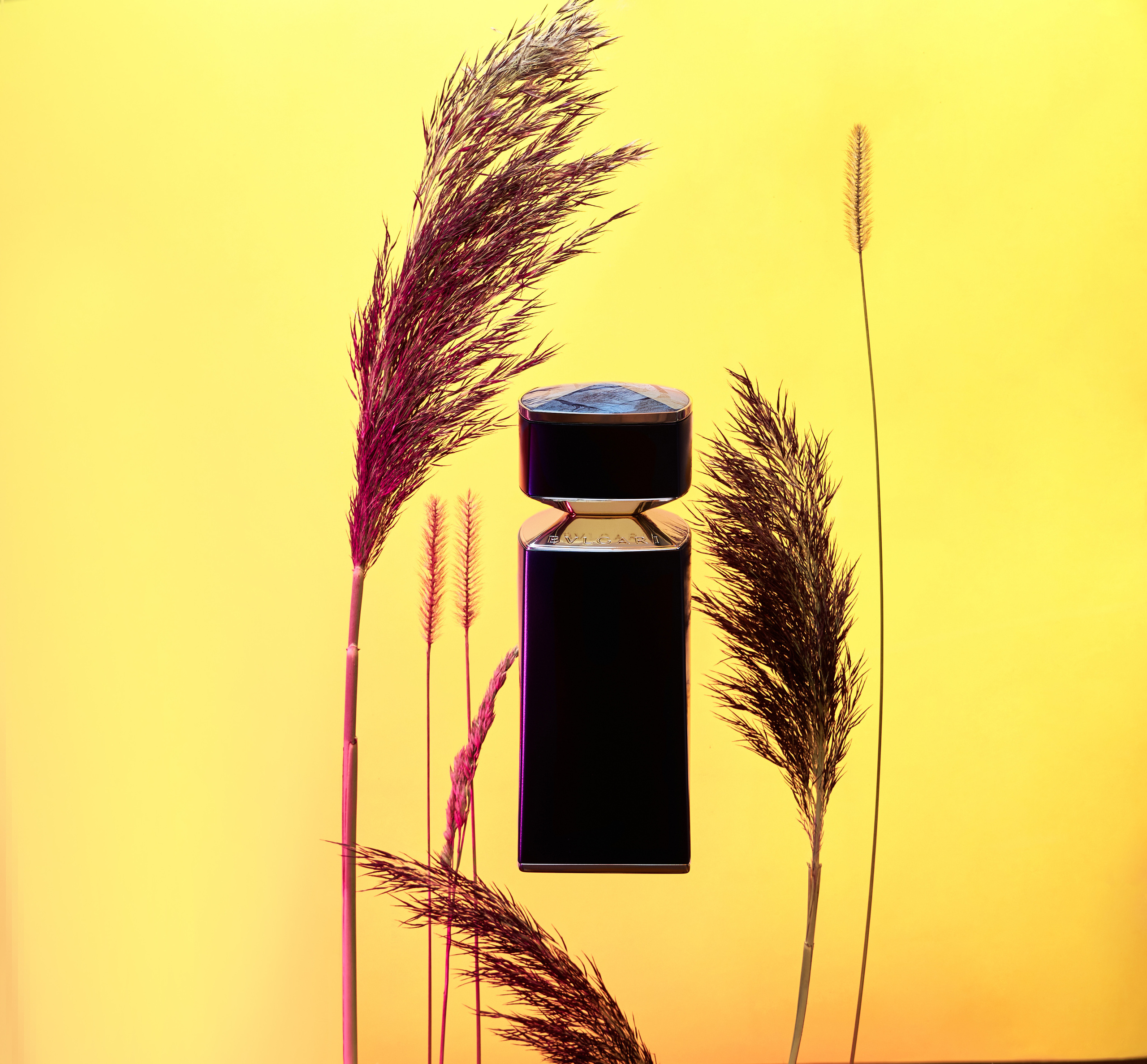 Духи bvlgari на фоне цветов 