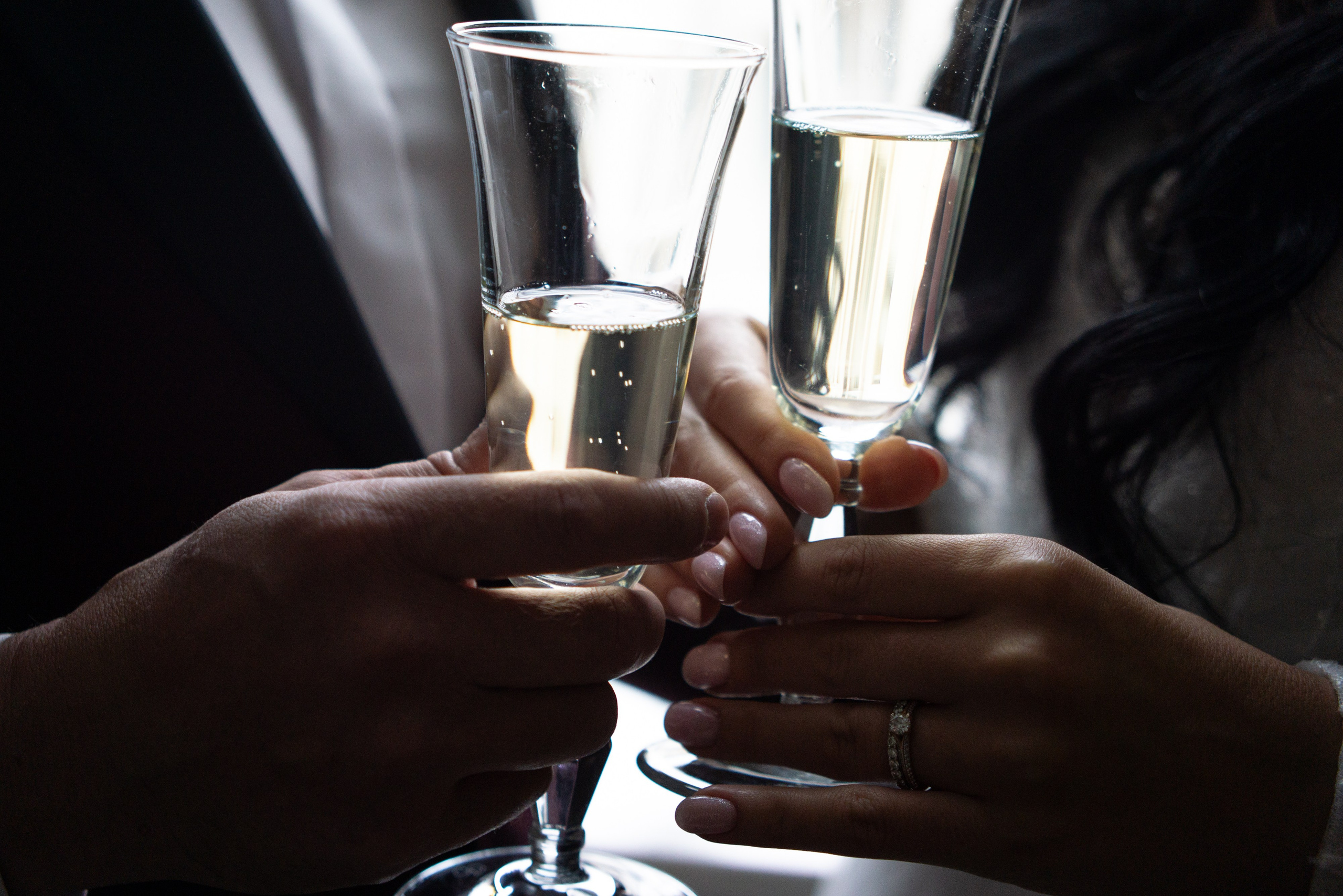 жених и невеста держат бокалы в отеле Индиго на свадебной фотосессии