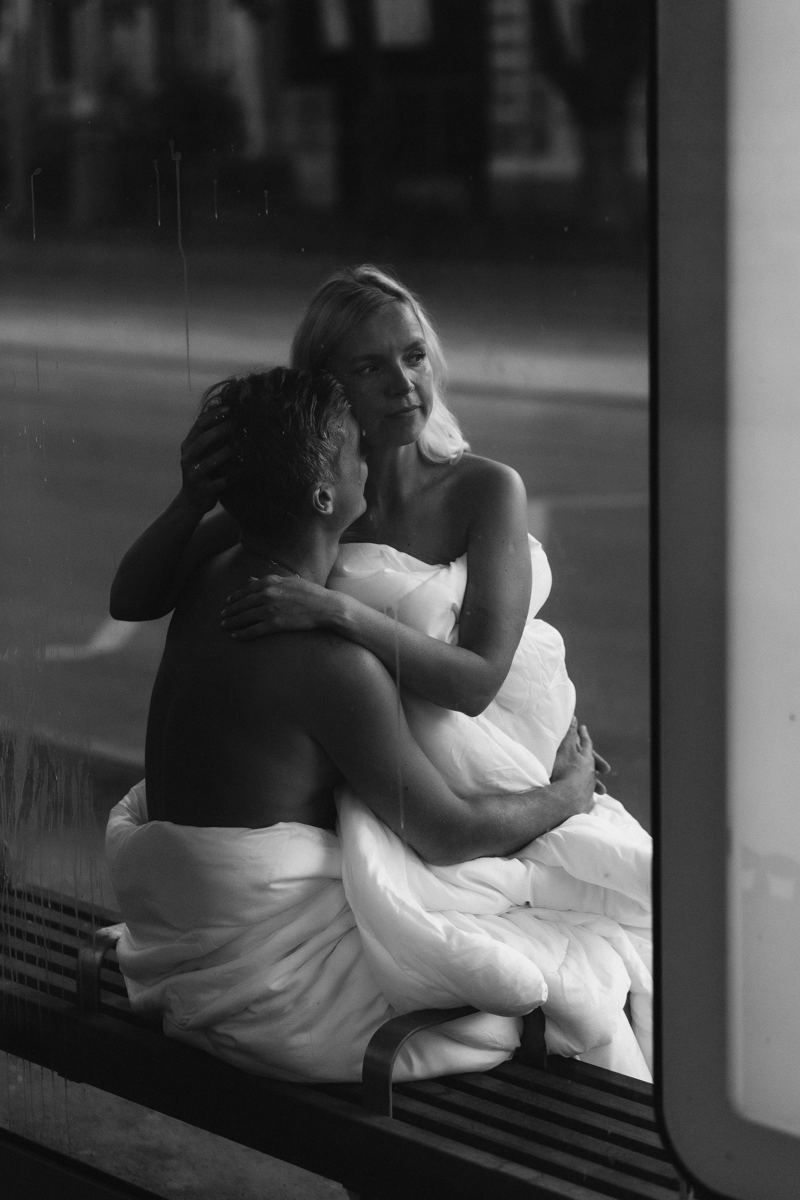 Чёрно-белая фотография пары в одеялах на остановке Таганрогского трамвая, уютный момент на улице Фрунзе