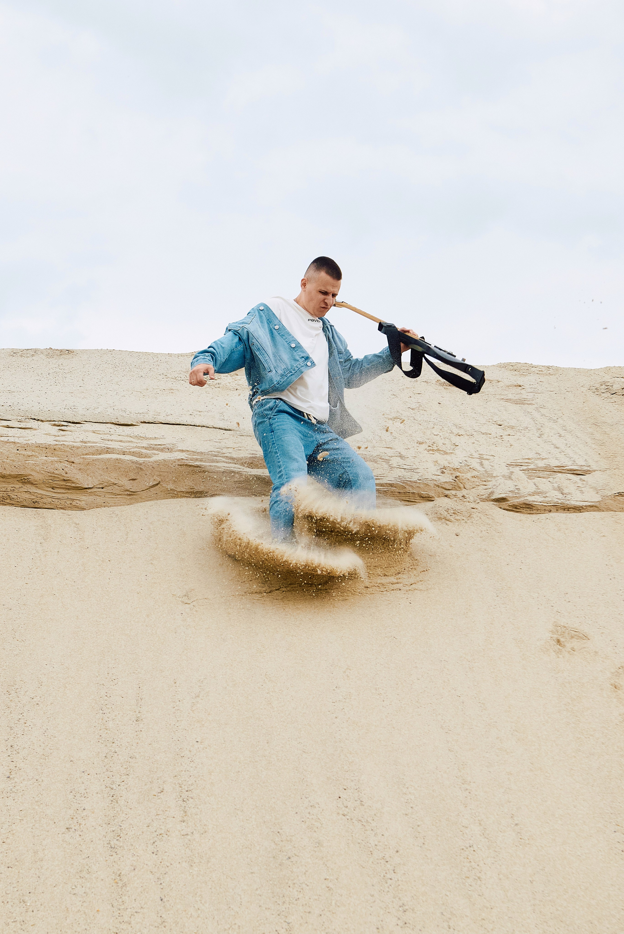 Парень играет на гитаре в пустыне