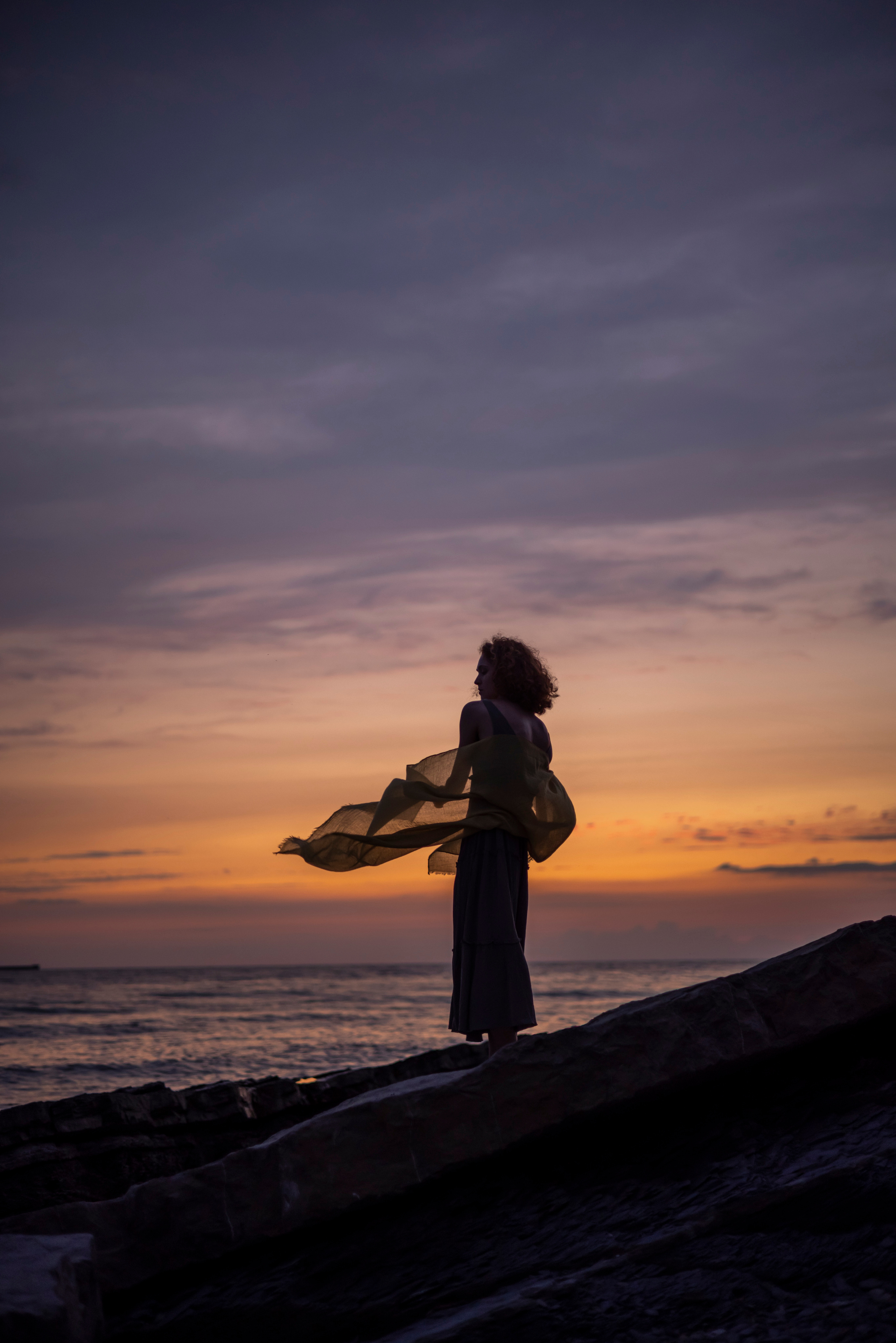 Девушка на фоне моря, с развивающимся платком на ветру