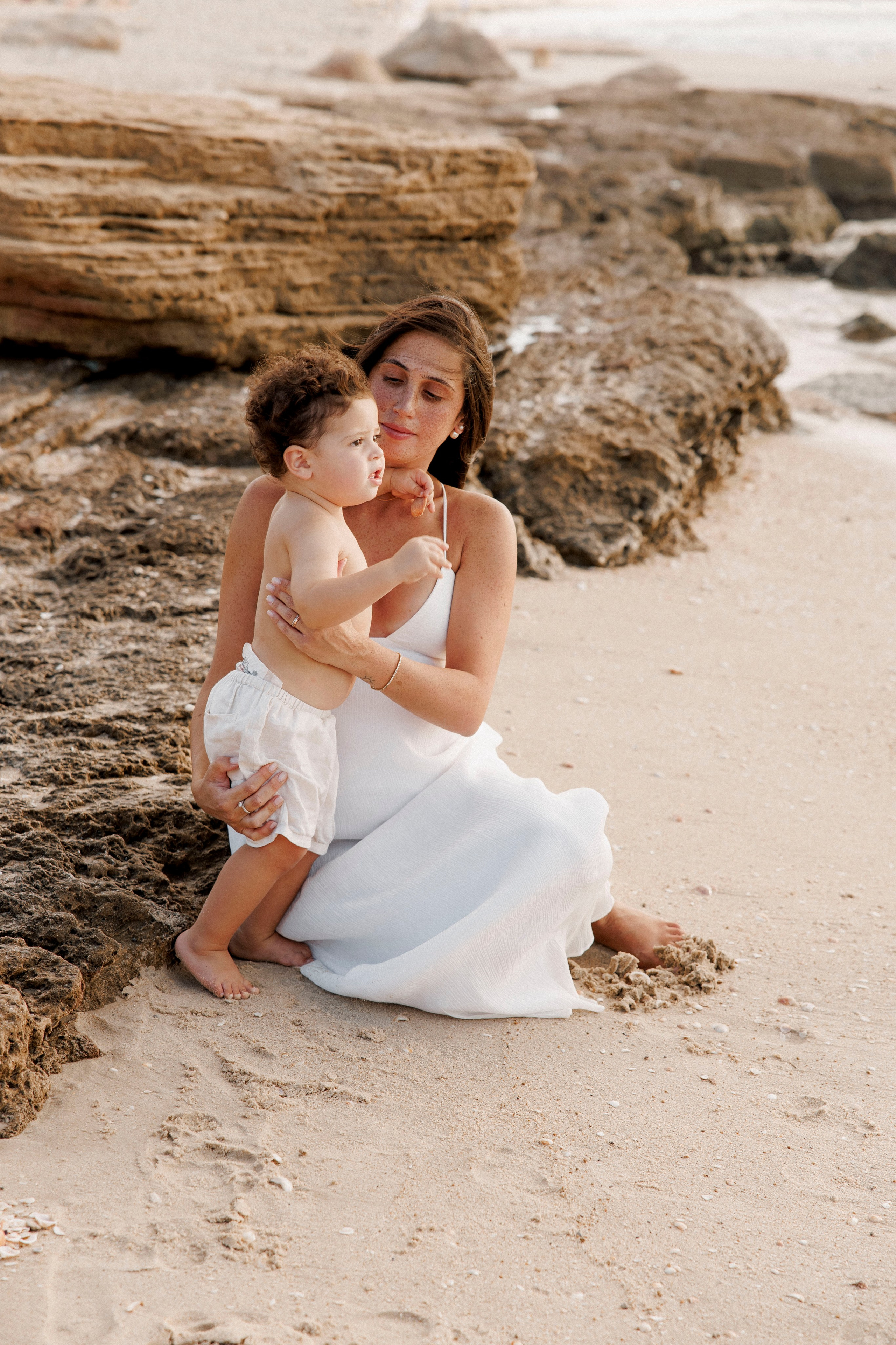 Pregnancy photoshoot near the sea. Wedding and family photographer