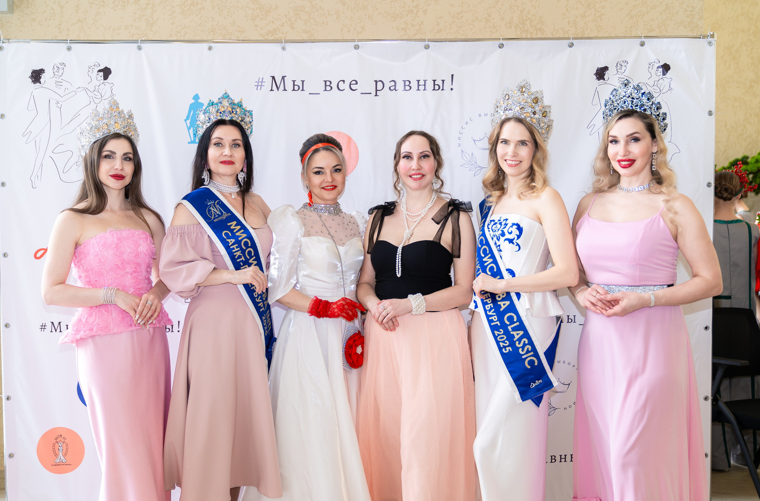 Пять участниц инклюзивного бала «Мы все равны» в вечерних платьях и коронах. Среди них Мисс Санкт-Петербург и Мисс Classic. Фотография Мальцев Евгений.