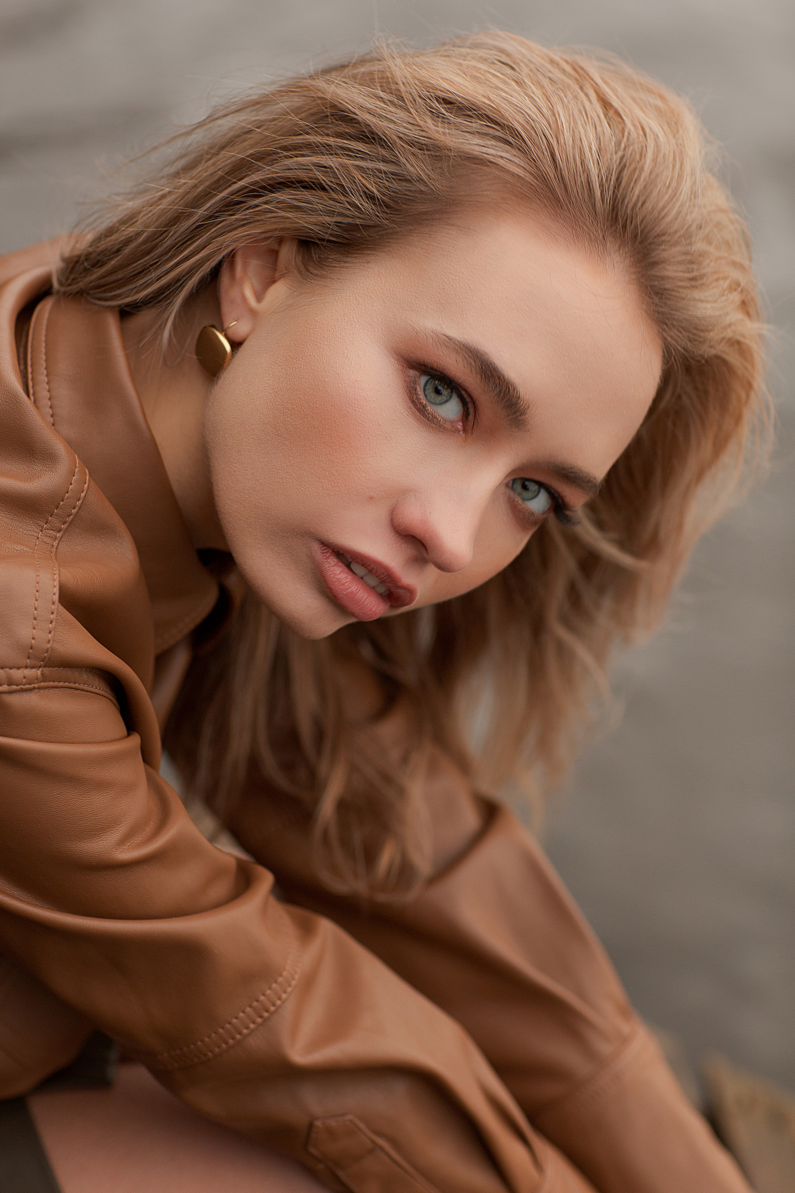 фото девушки в коричневой кожаной куртке на фоне воды