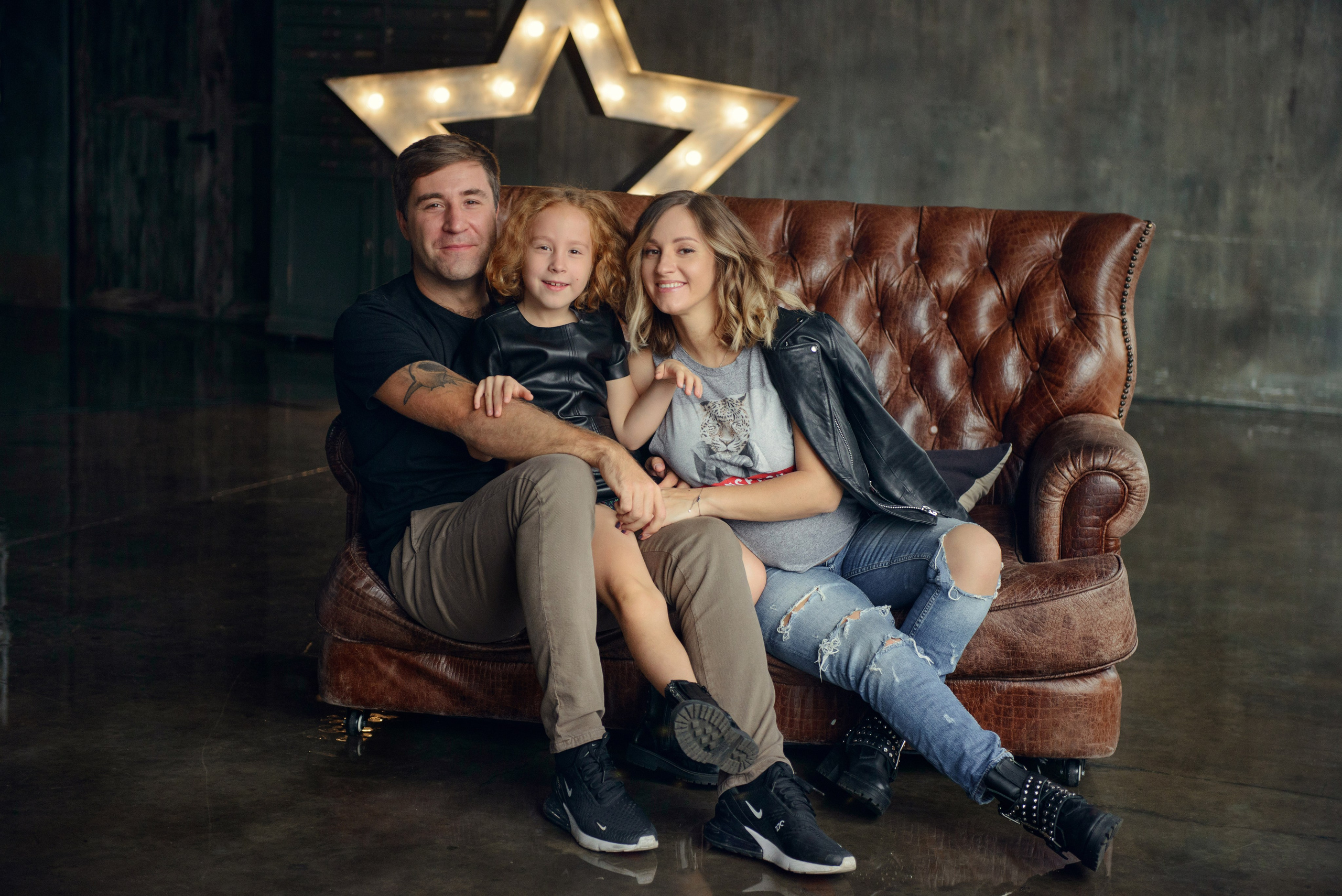 Family photo shoot with a pregnant woman in a loft studio, rock and roll style