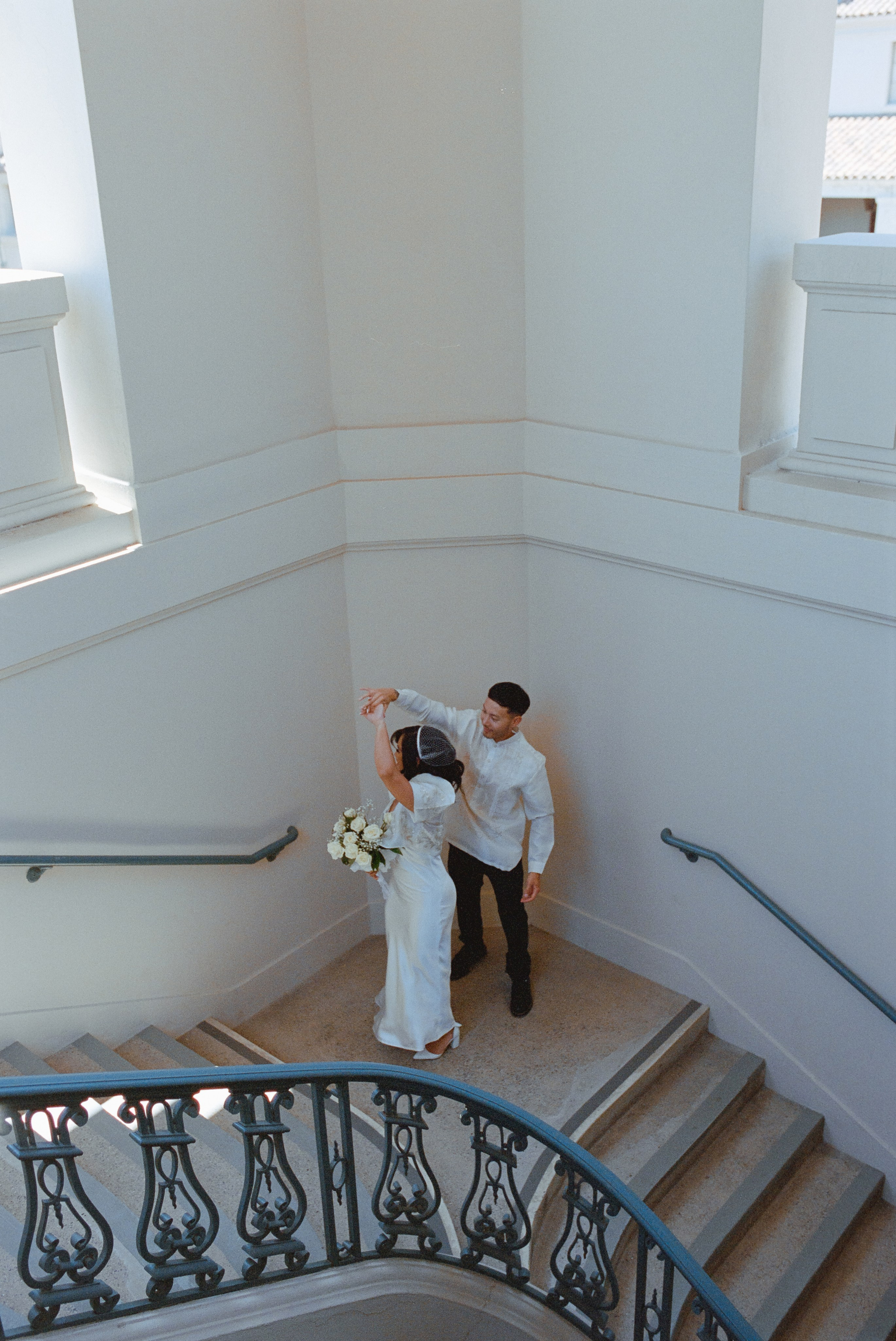 a film photo of a couple just married in city hall