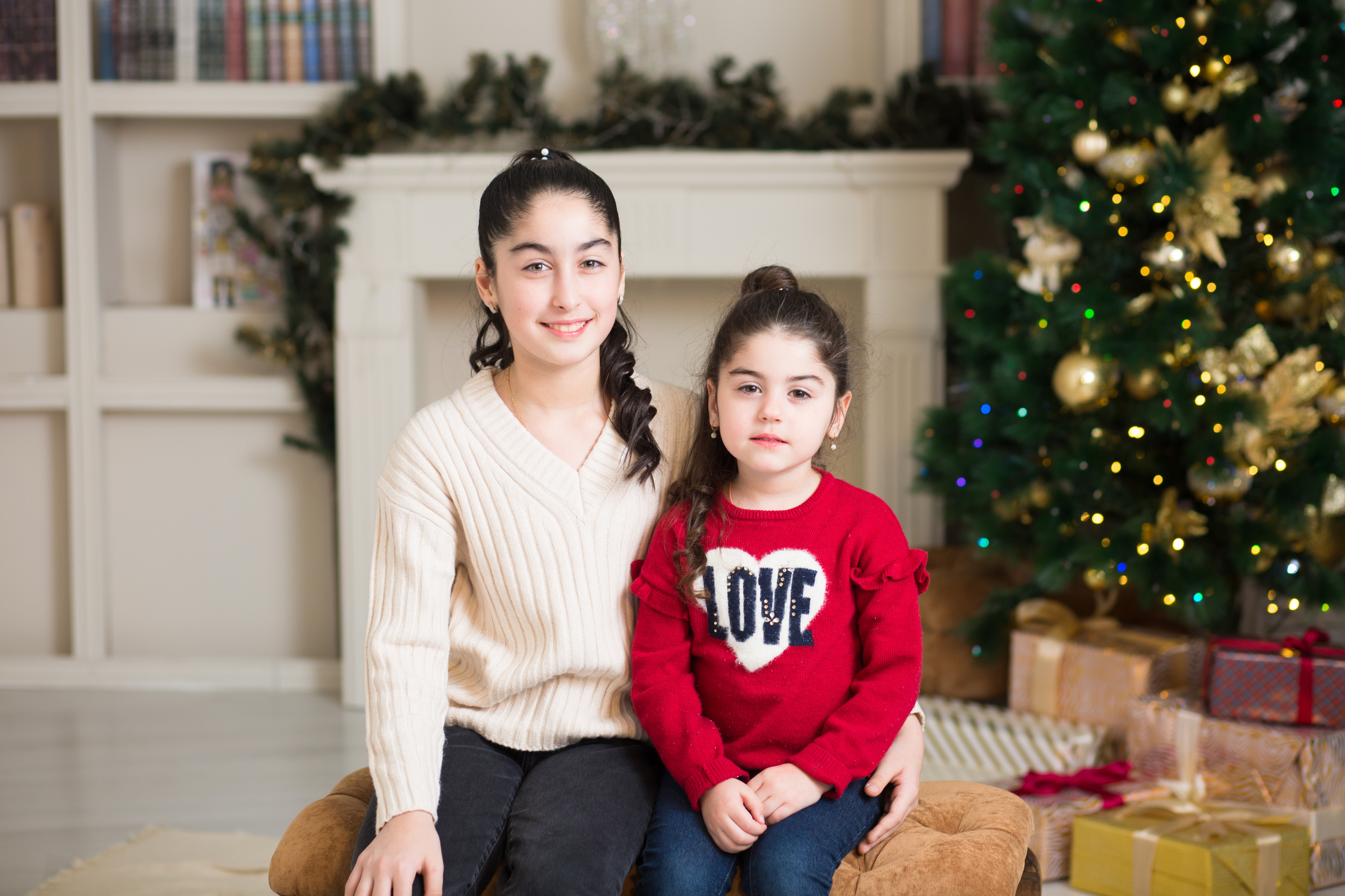 две сестры сидят на пуфе