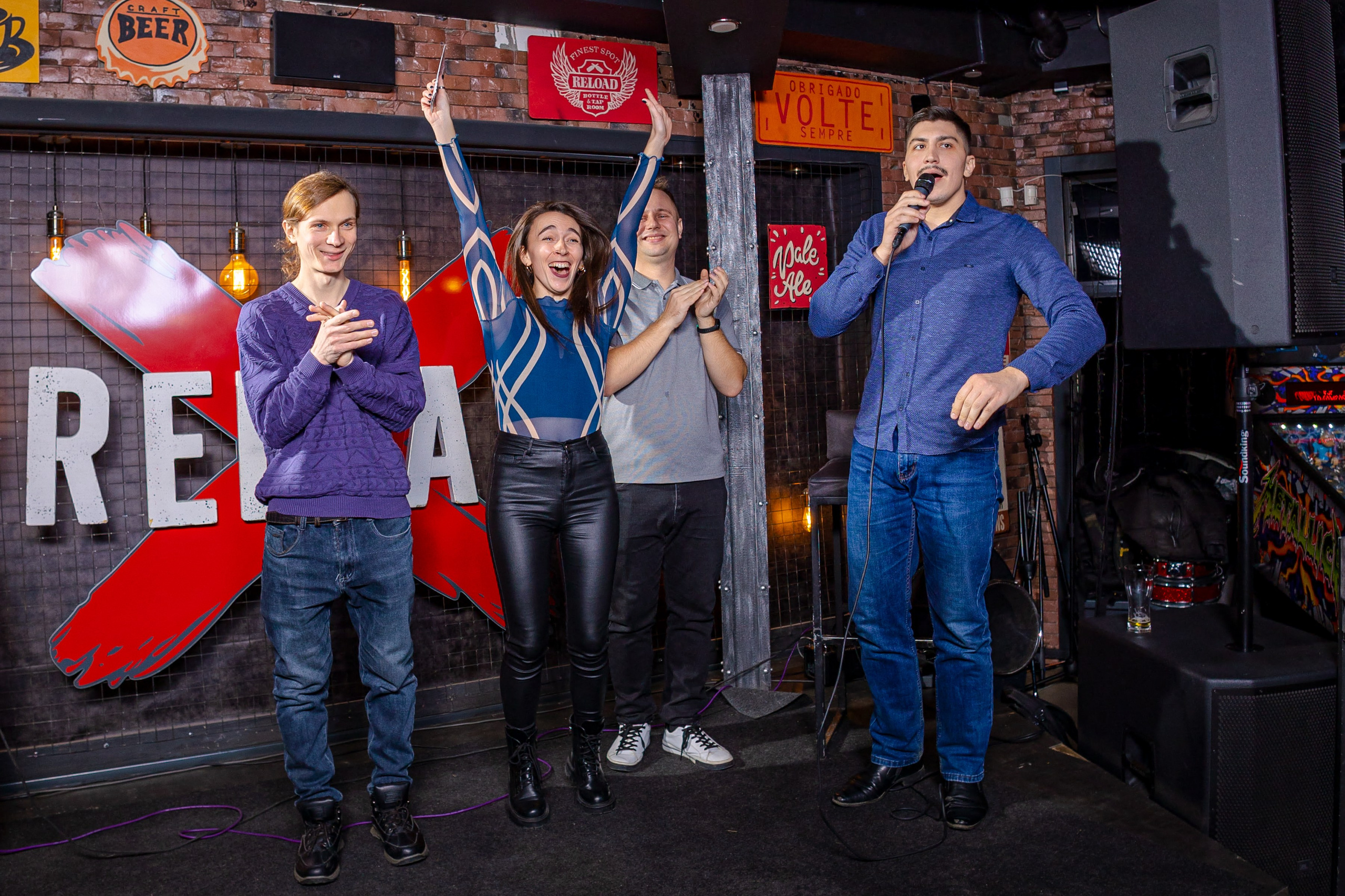 Фотография Standup клуба Кемерово в баре reload выступление комики корпоратив девушка поднимает руки