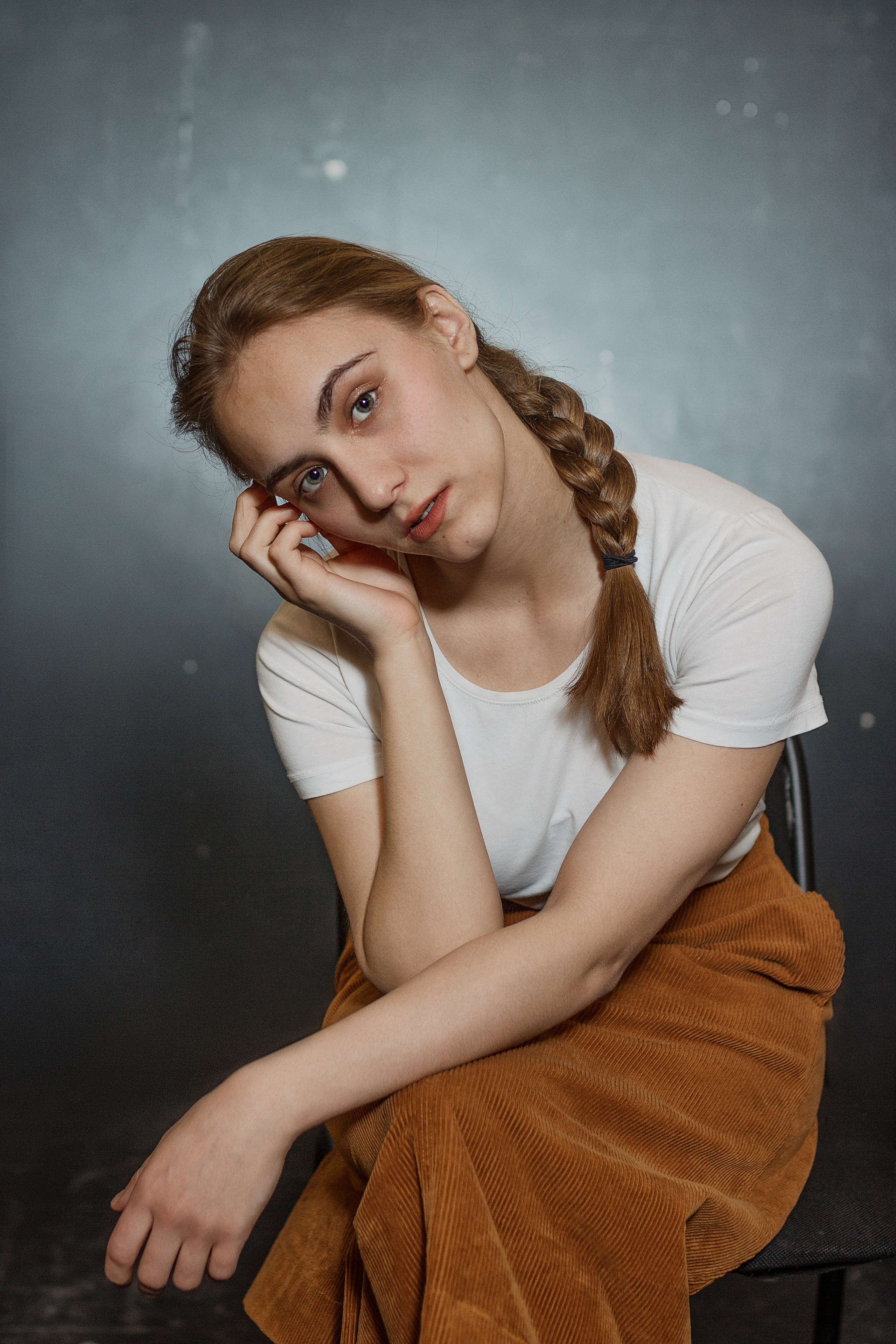 Молодая актриса позирует сидя на стуле