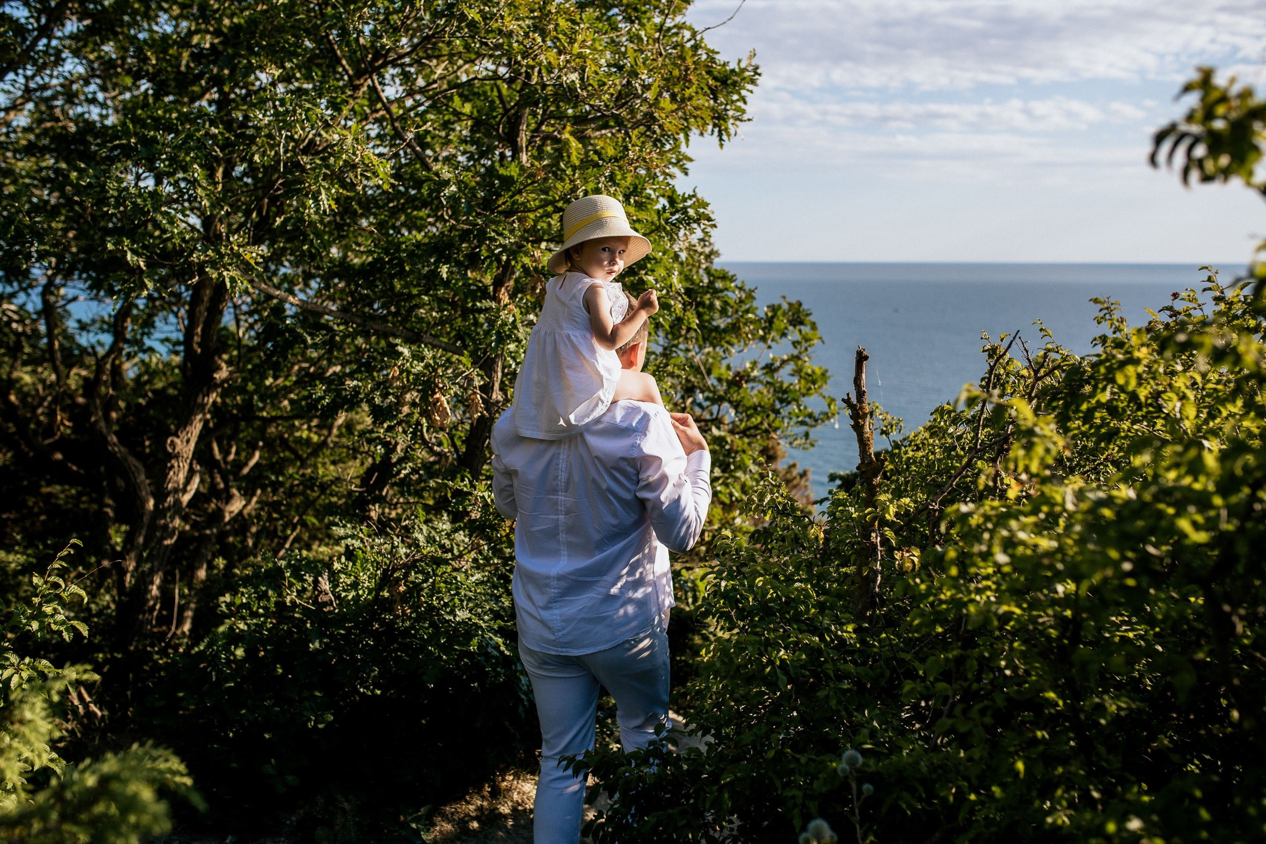 Дочка на плечах у папы во время фототура по Анапе.