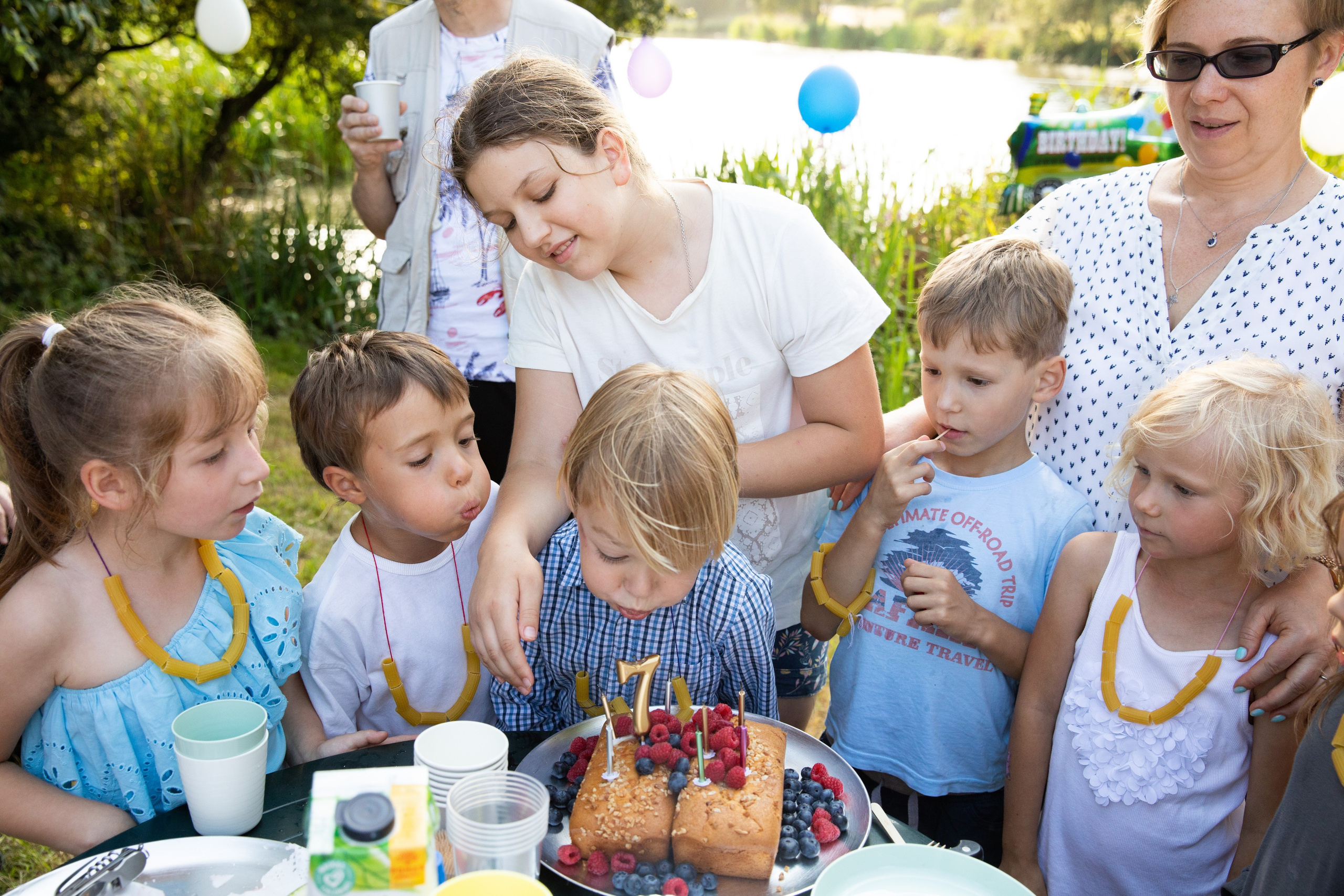 Many children celebrate their friend's birthday in the park