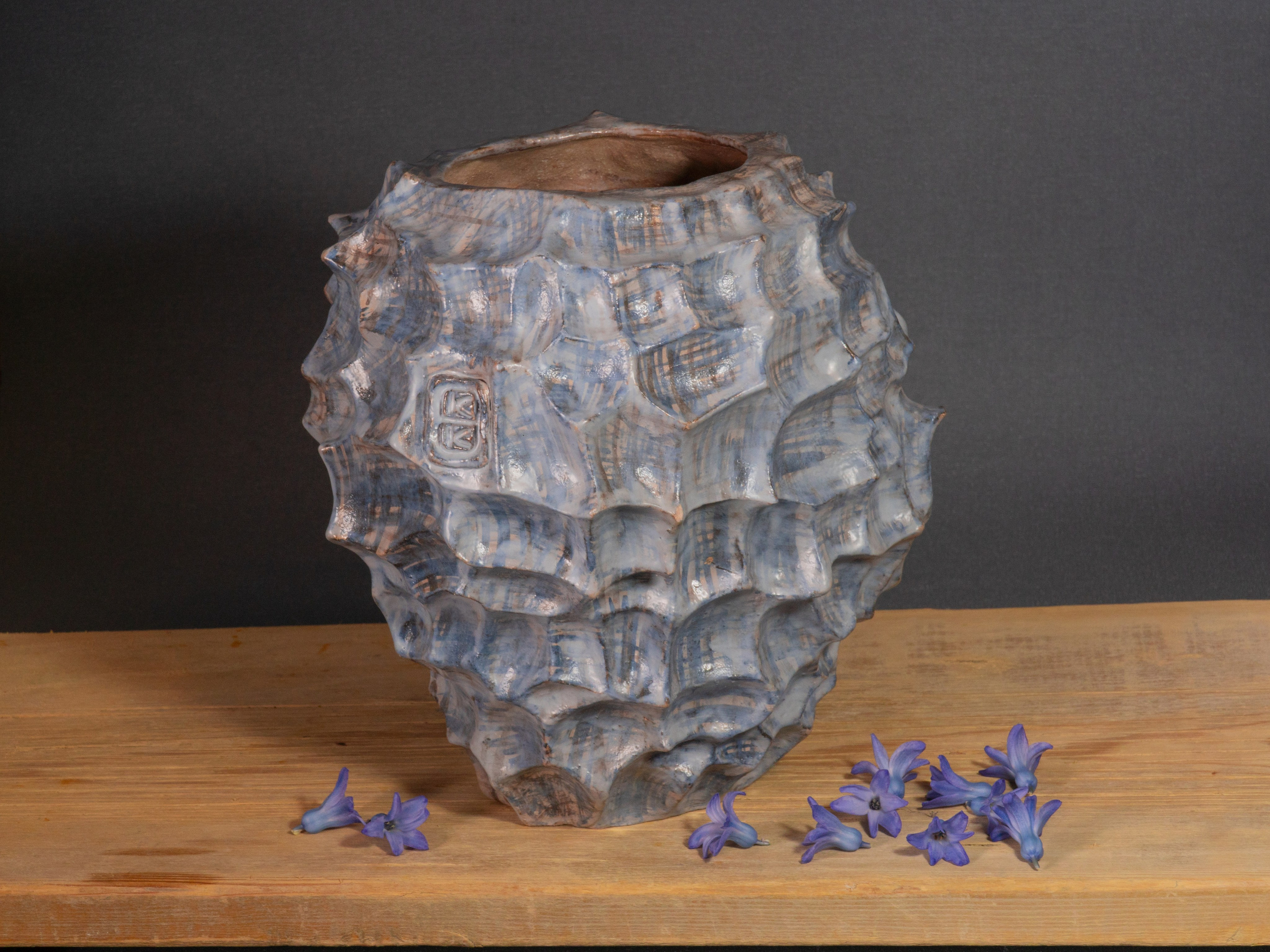 Голубая керамическая ваза на темном фоне