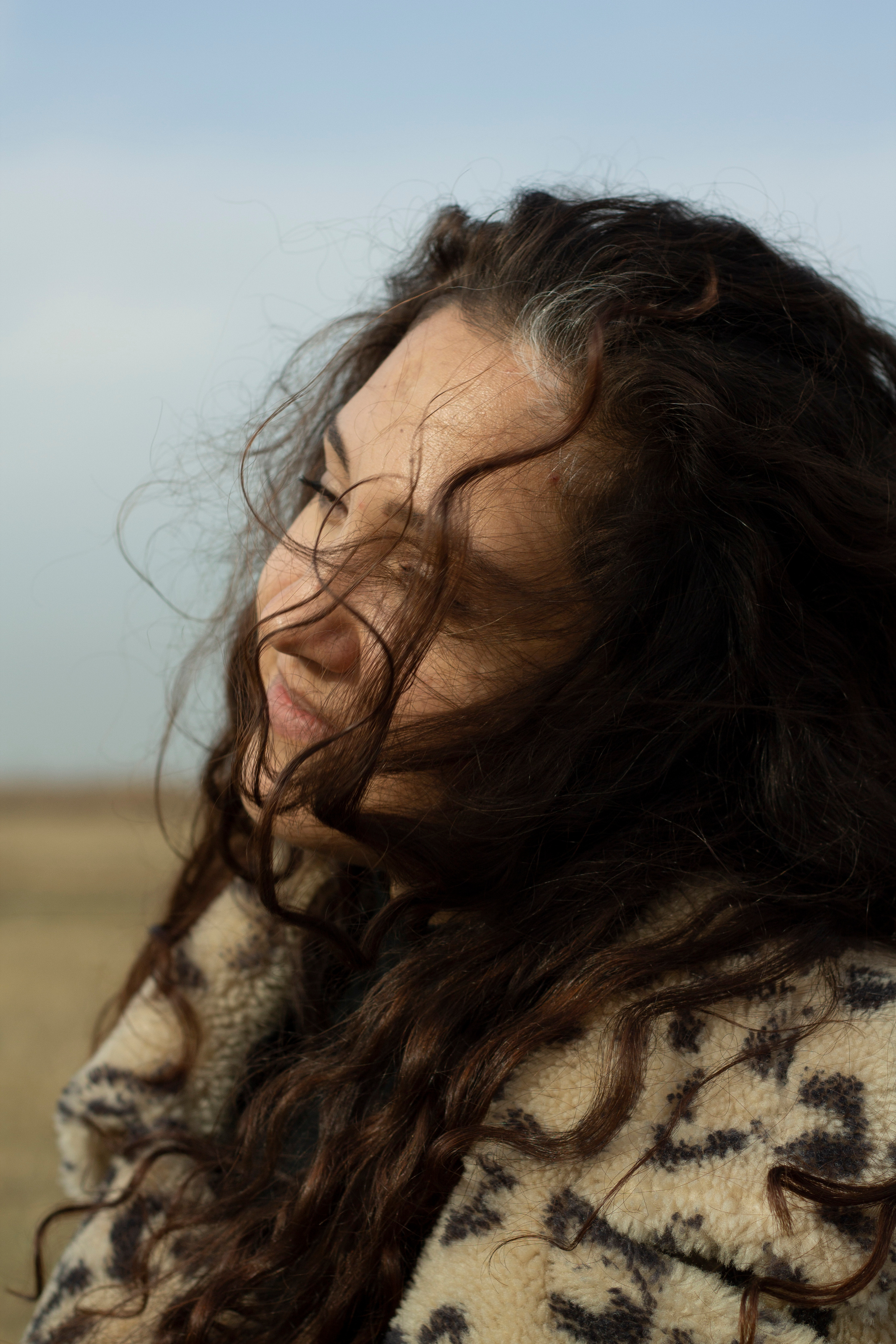 girl in the field in the leopard fur jacket by Anna Karamurzina