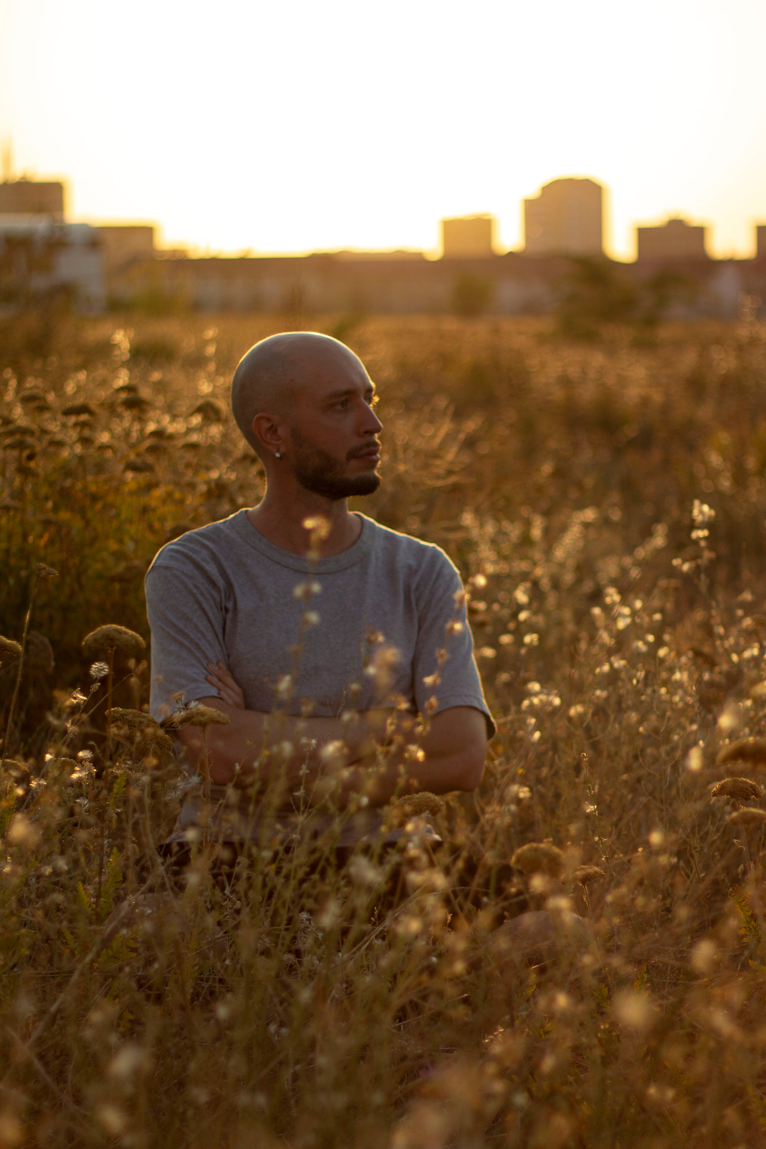 Man sits in the grass in the sunset light