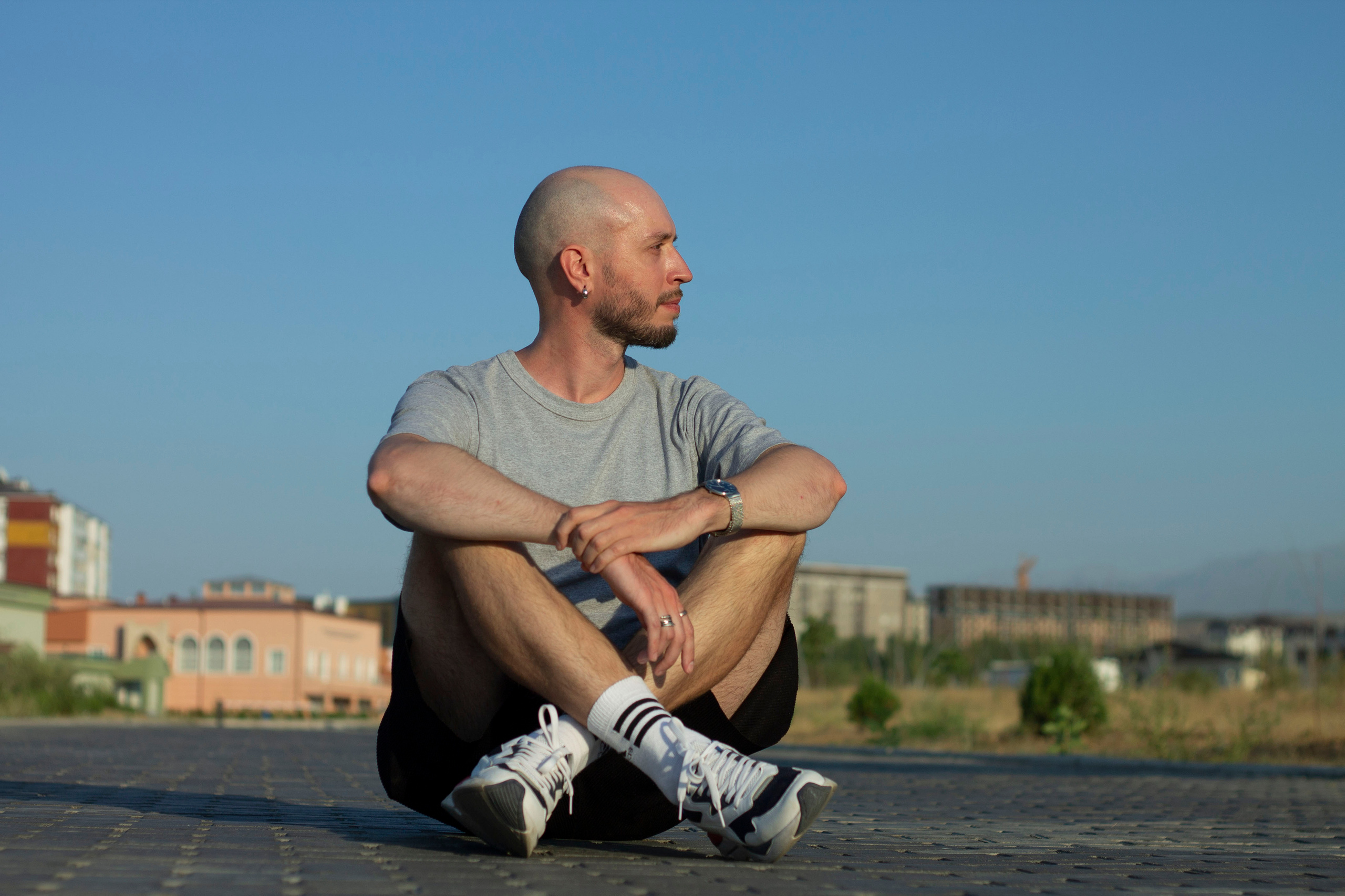 Man sitting on the road and looking to the right