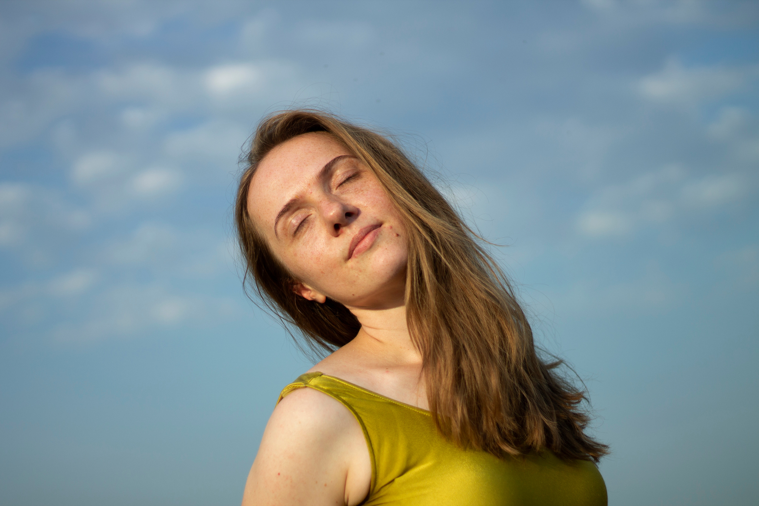 Lady in the golden t-shirt on the sky