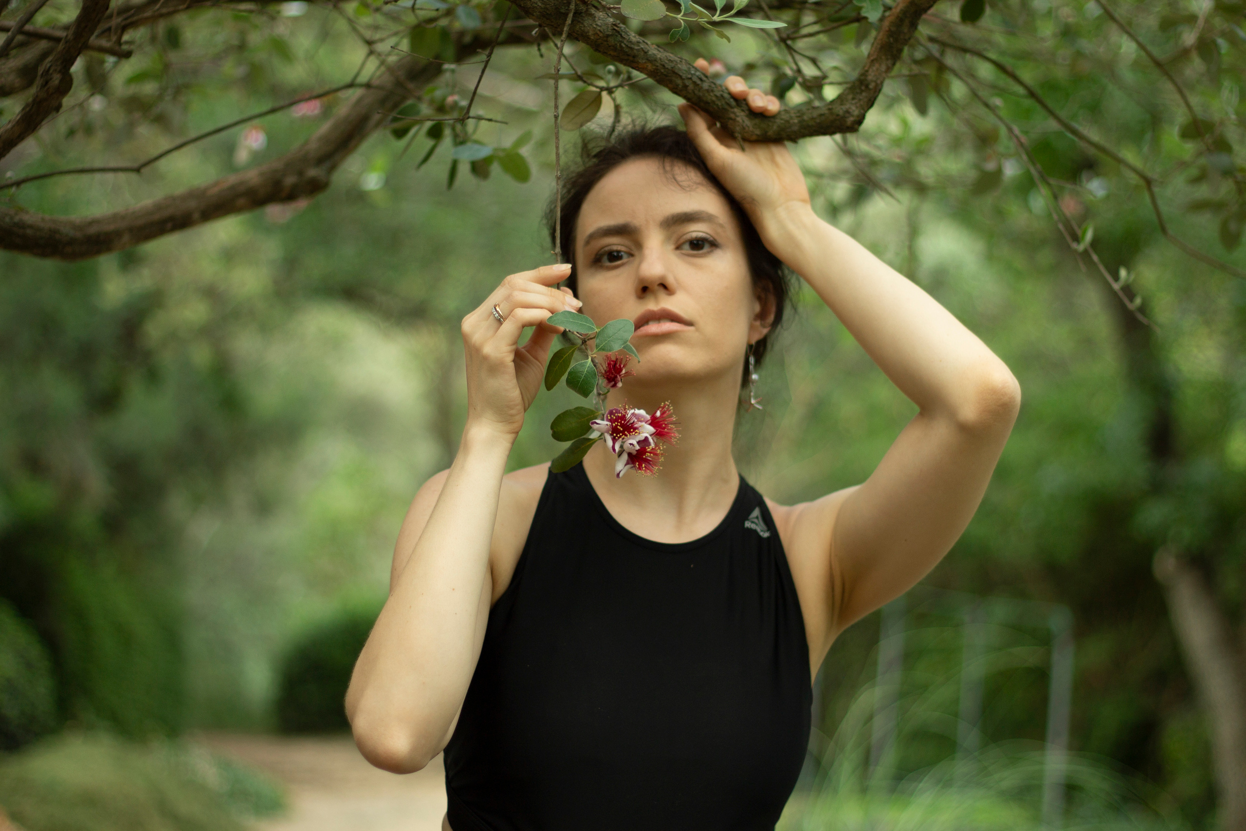 Girl in the forest with a flower in her hands