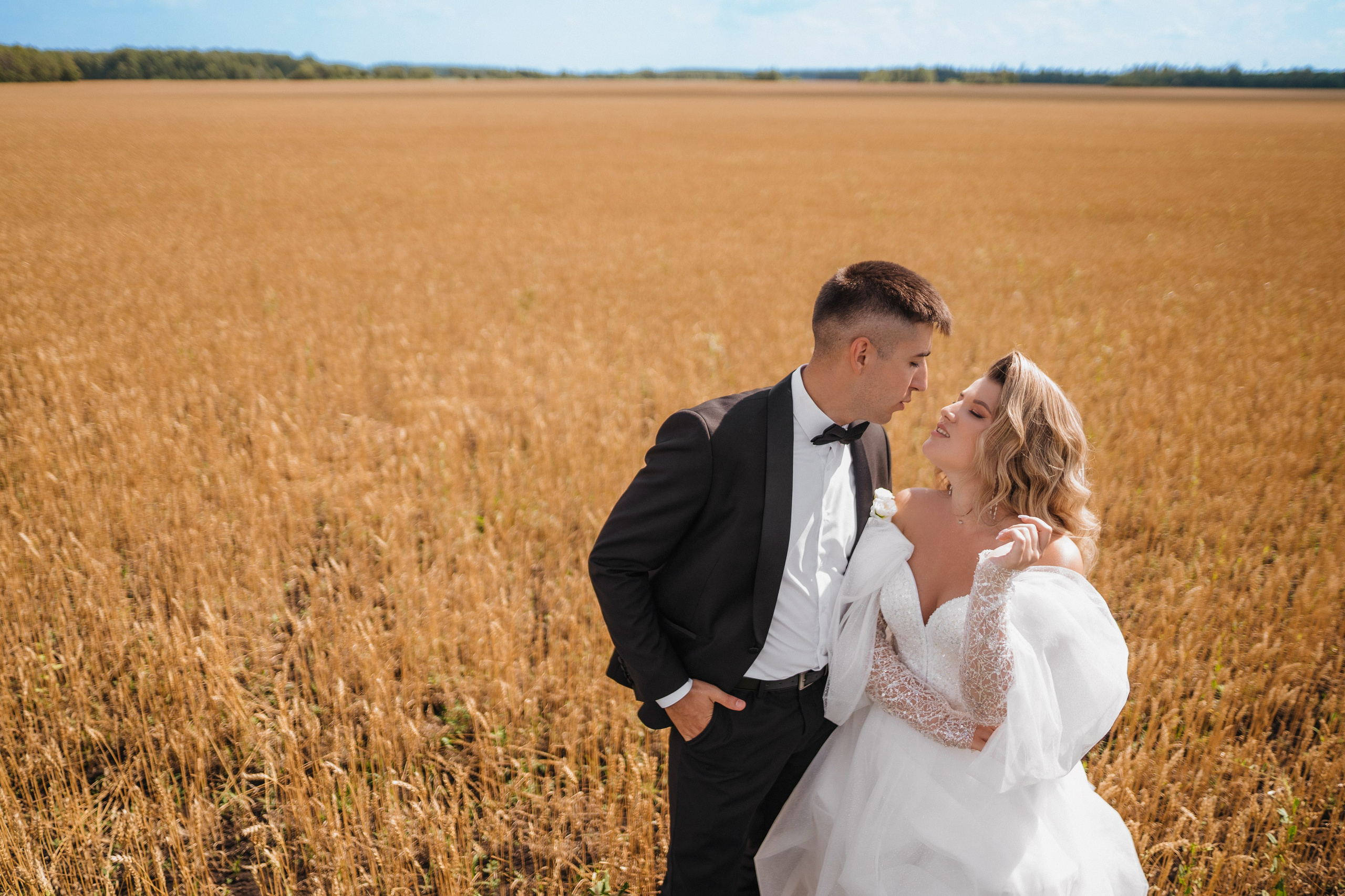 Жених и невеста гуляют в пшеничном поле