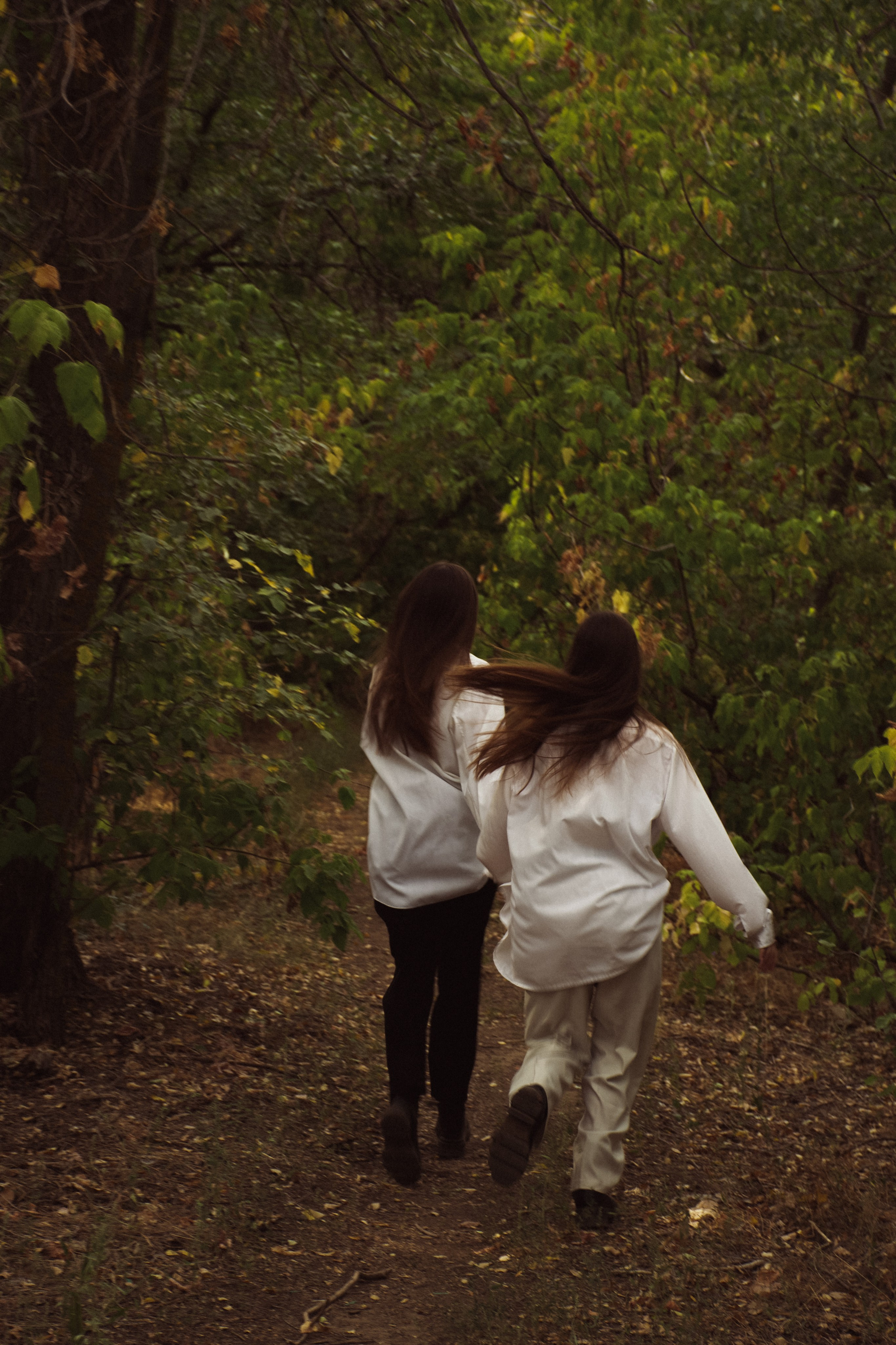 Дуэт сестер в естественной фотосессии среди деревьев