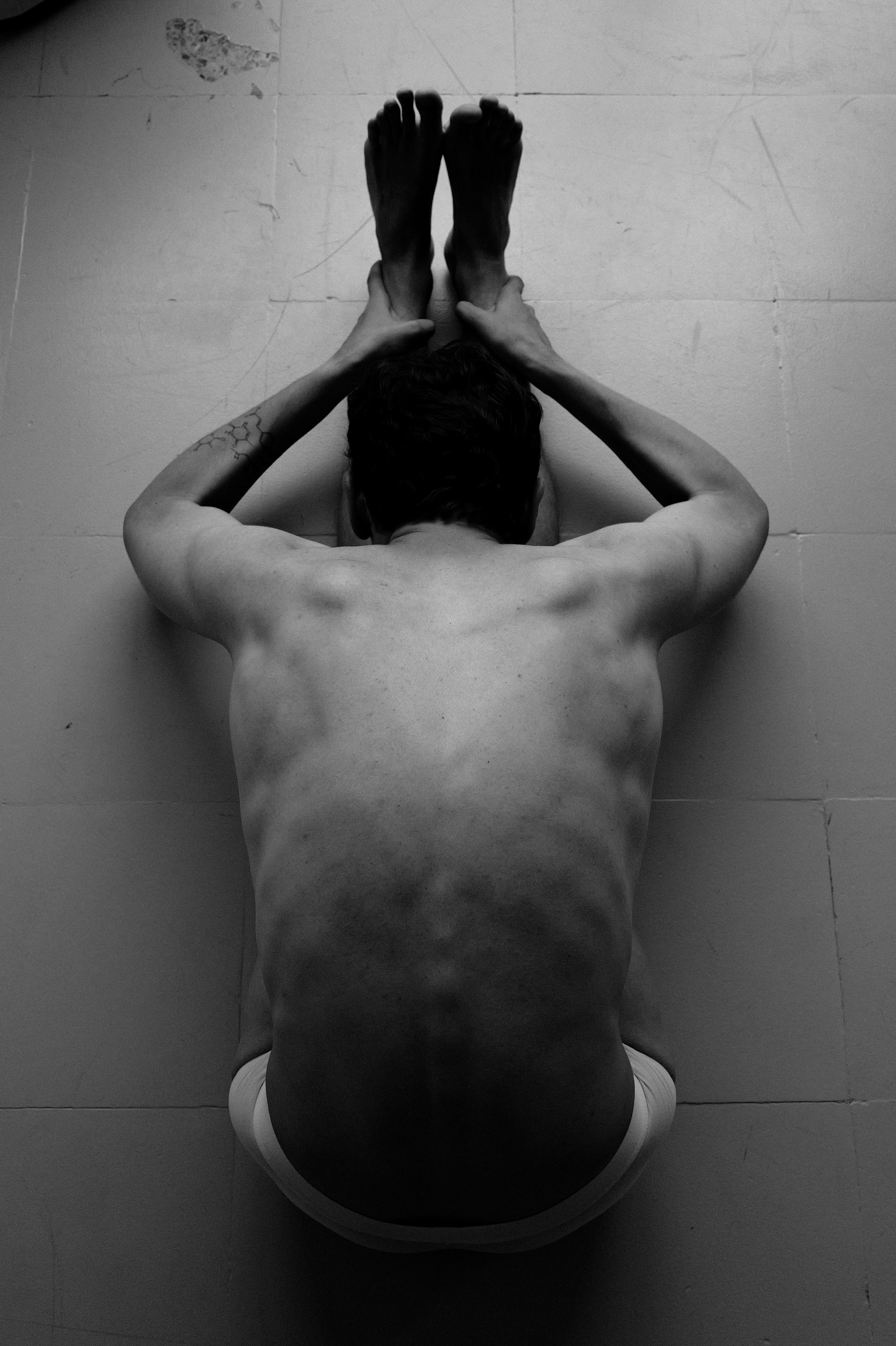 Elegant black and white shot of a man doing yoga-inspired movement in Barcelona