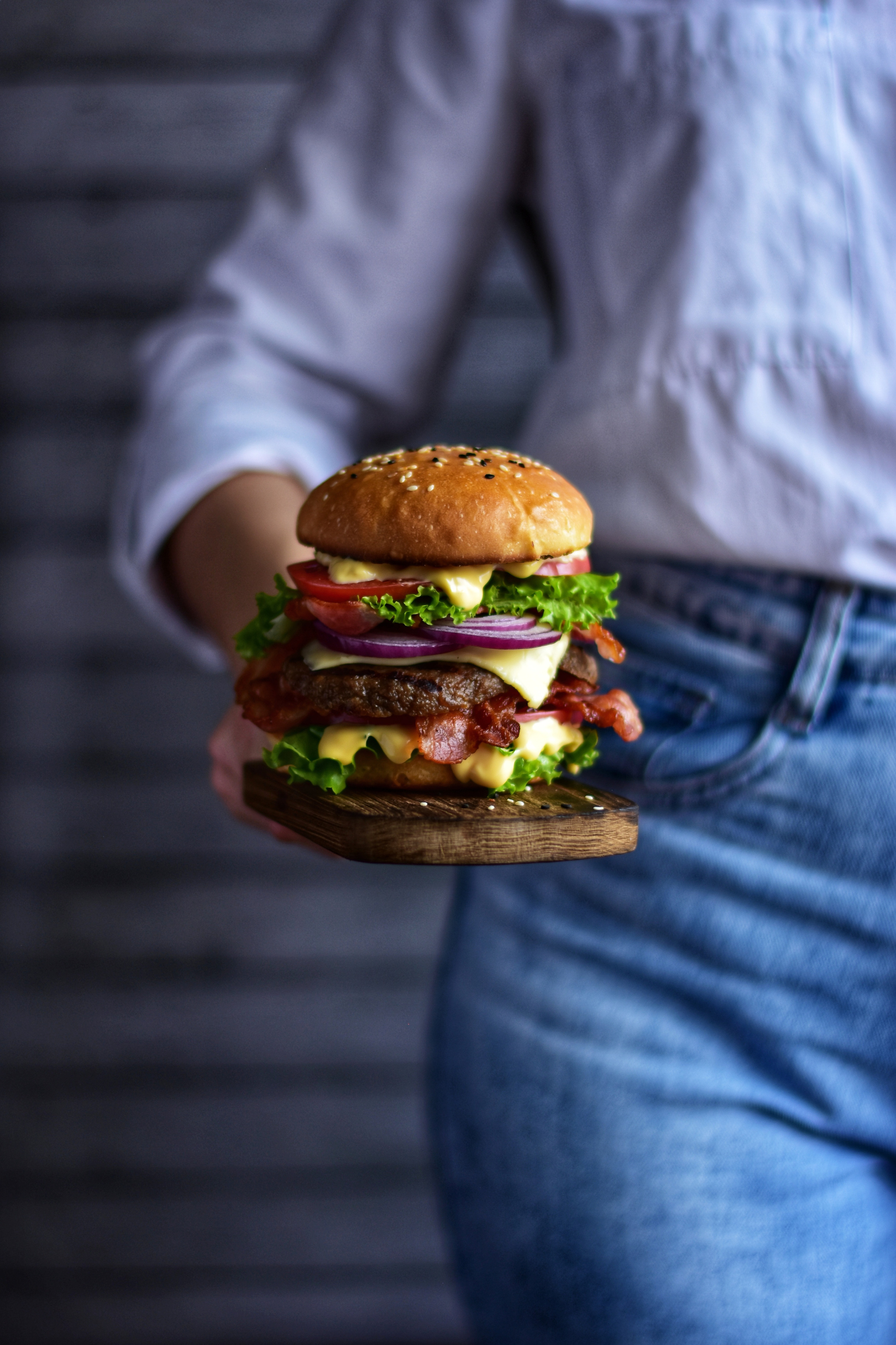 женщина  держит в руке гамбургер