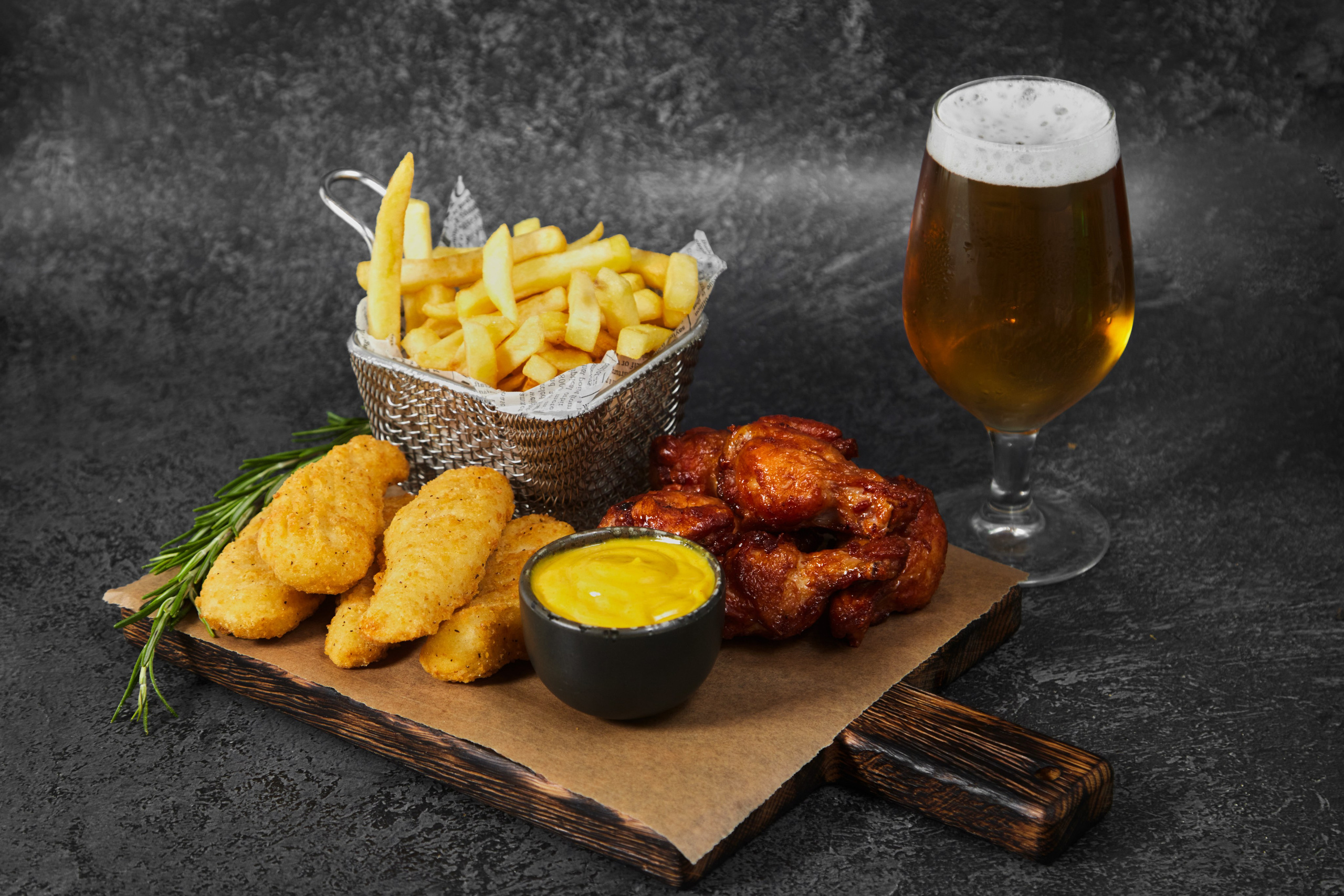 Картофель фри и наггетсы с соусом и пивом.