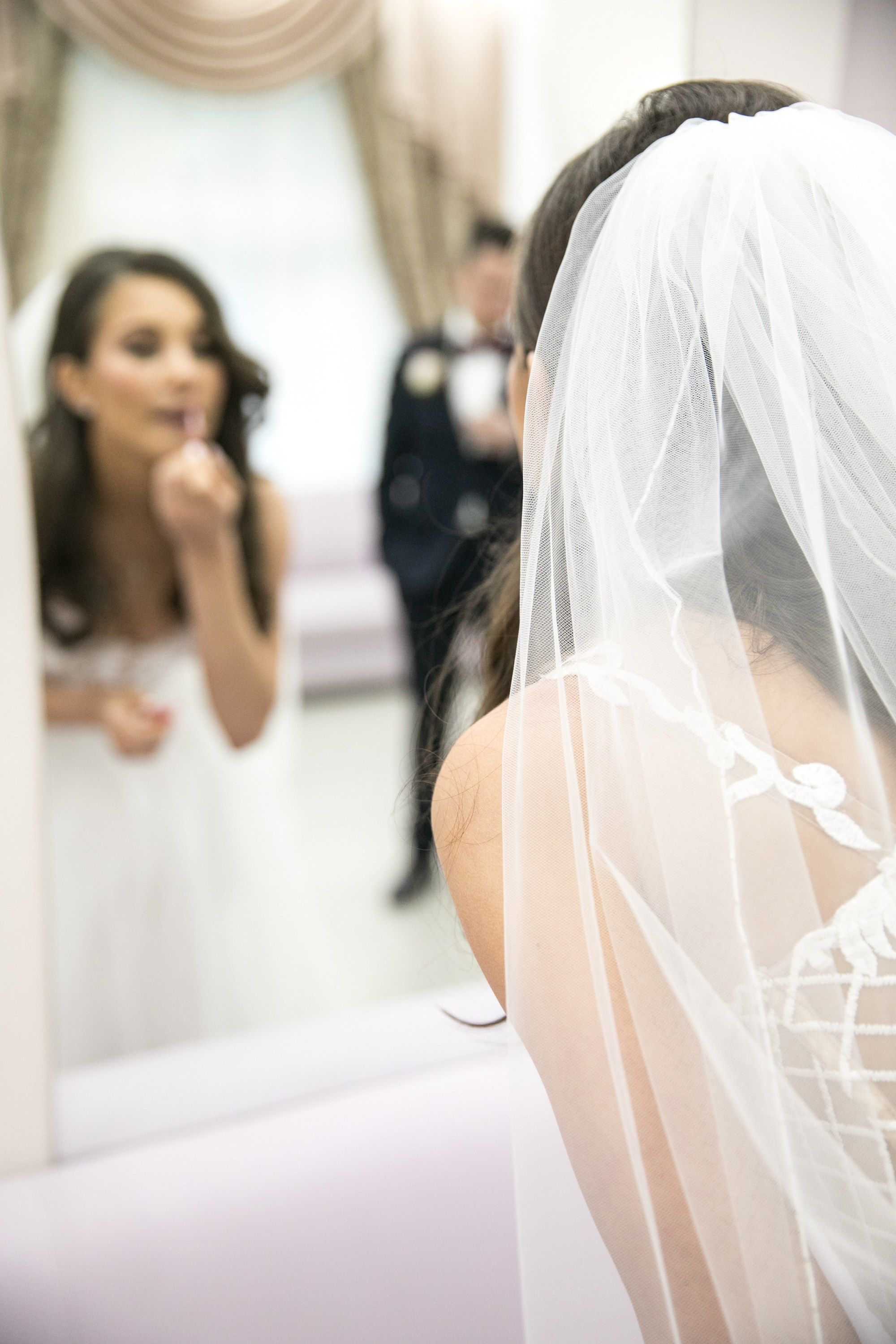 Wedding photo session. Bride paints her lips