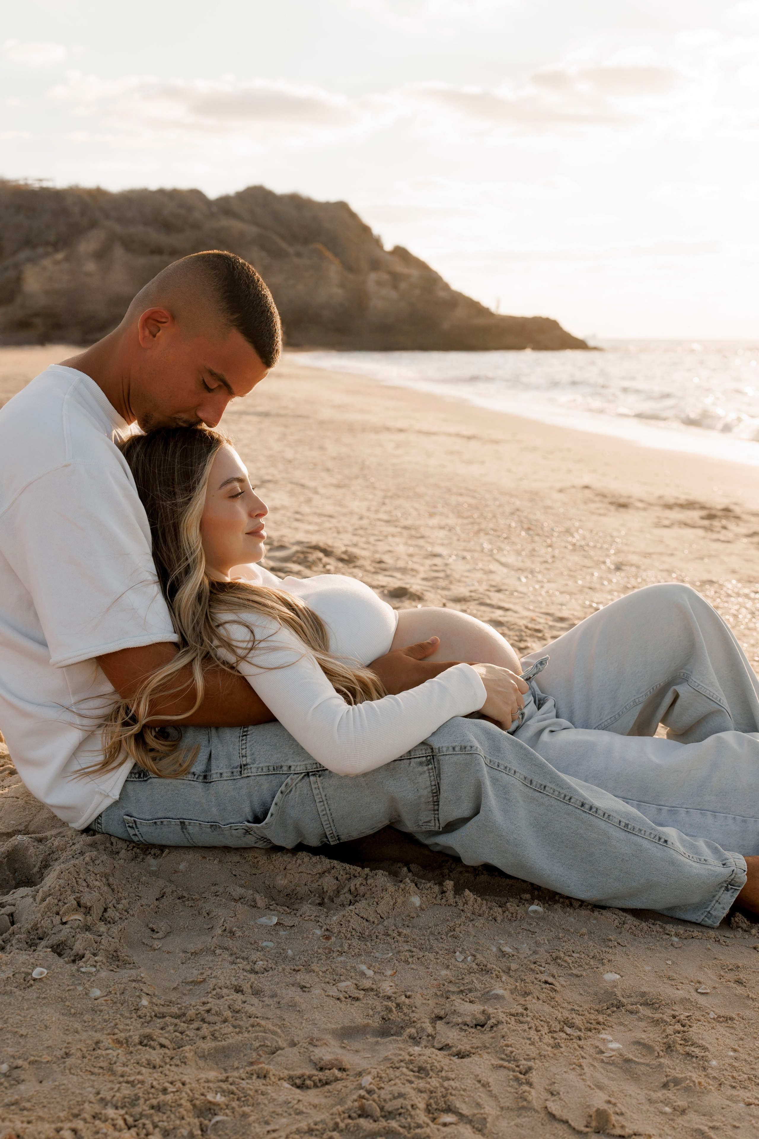 Pregnancy photoshoot near the sea. Wedding and family photographer