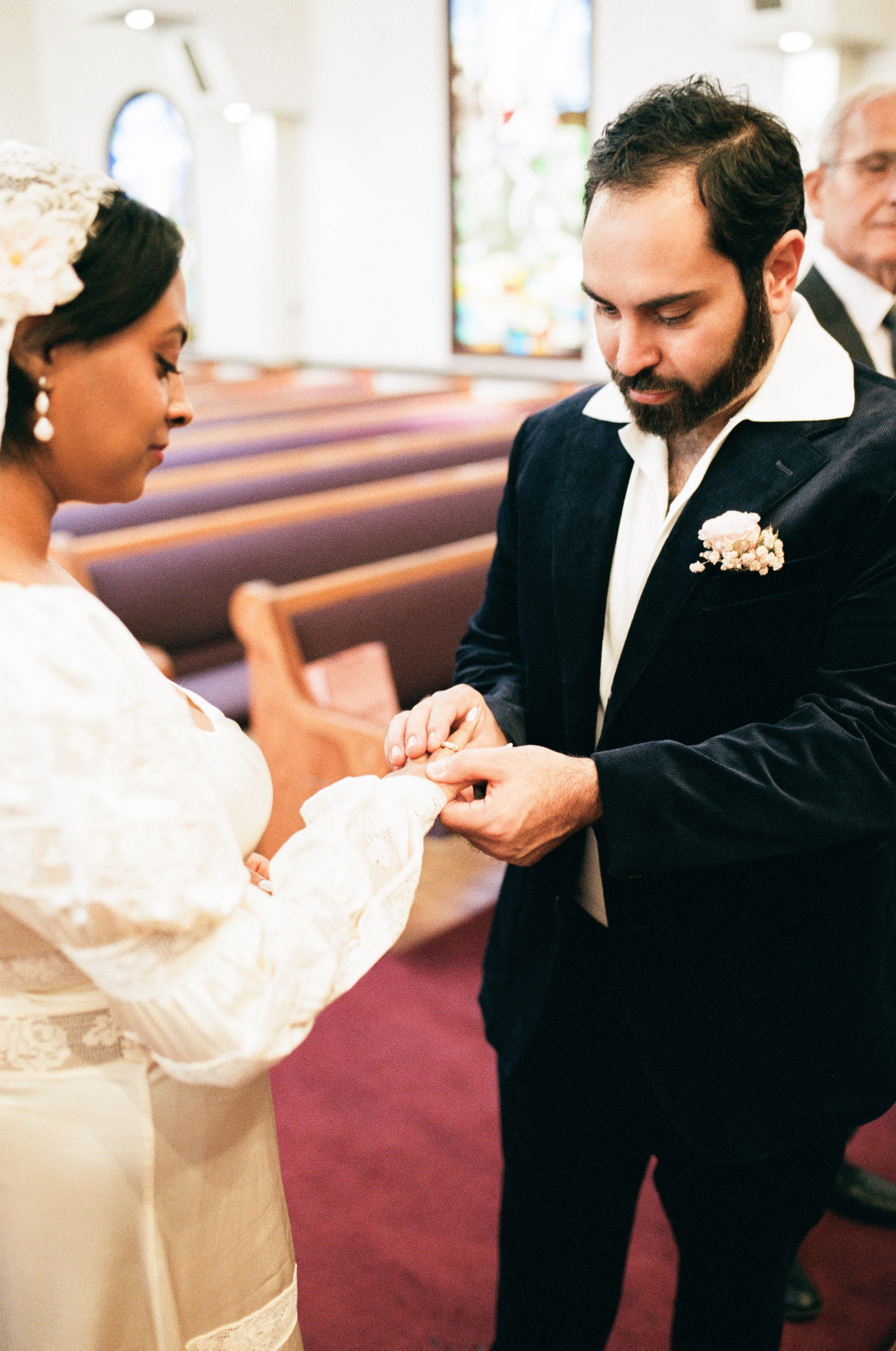 bride and groom exchanging rings in a church wedding in Glendale