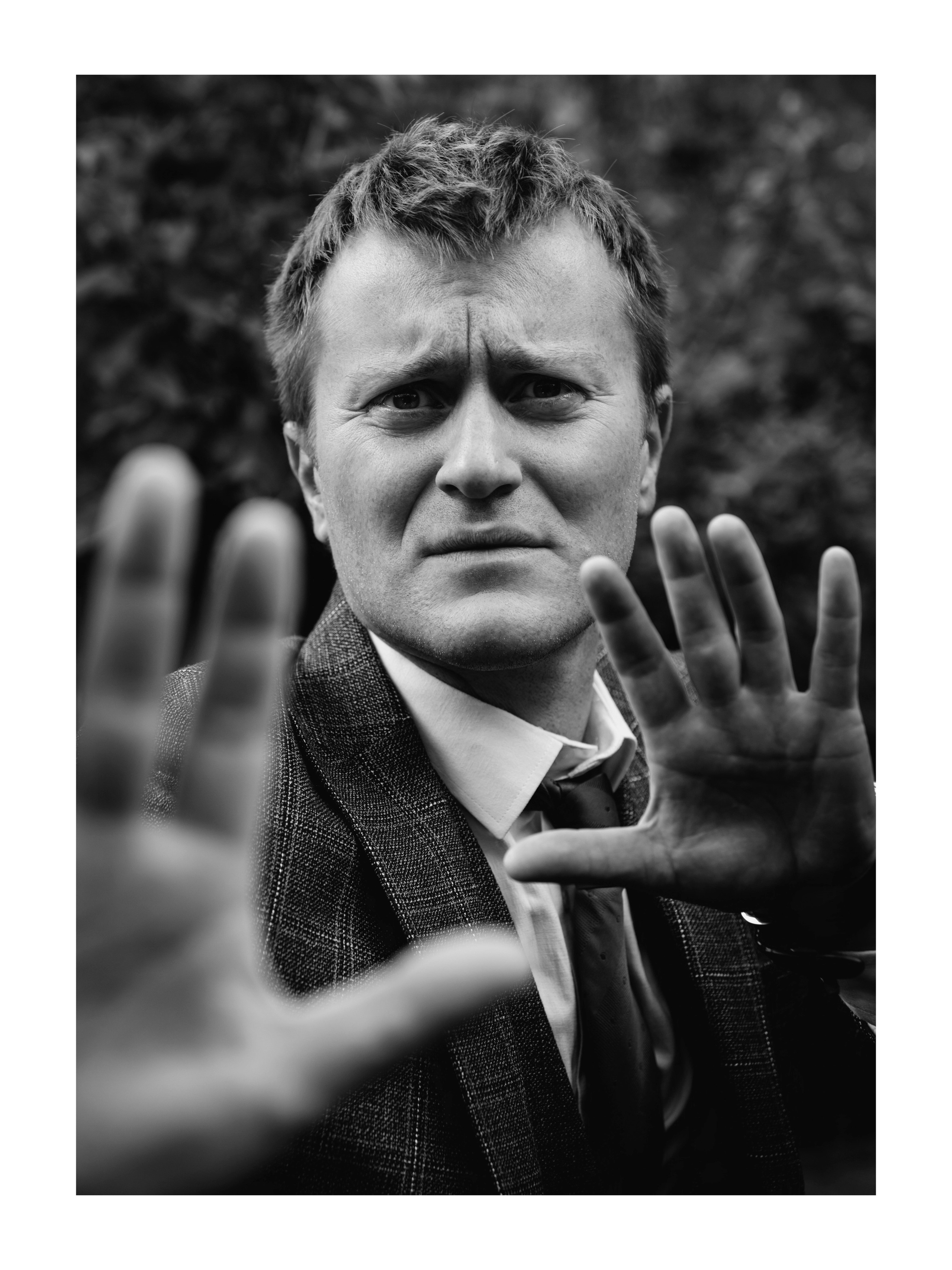 мужчина отгораживается от камеры