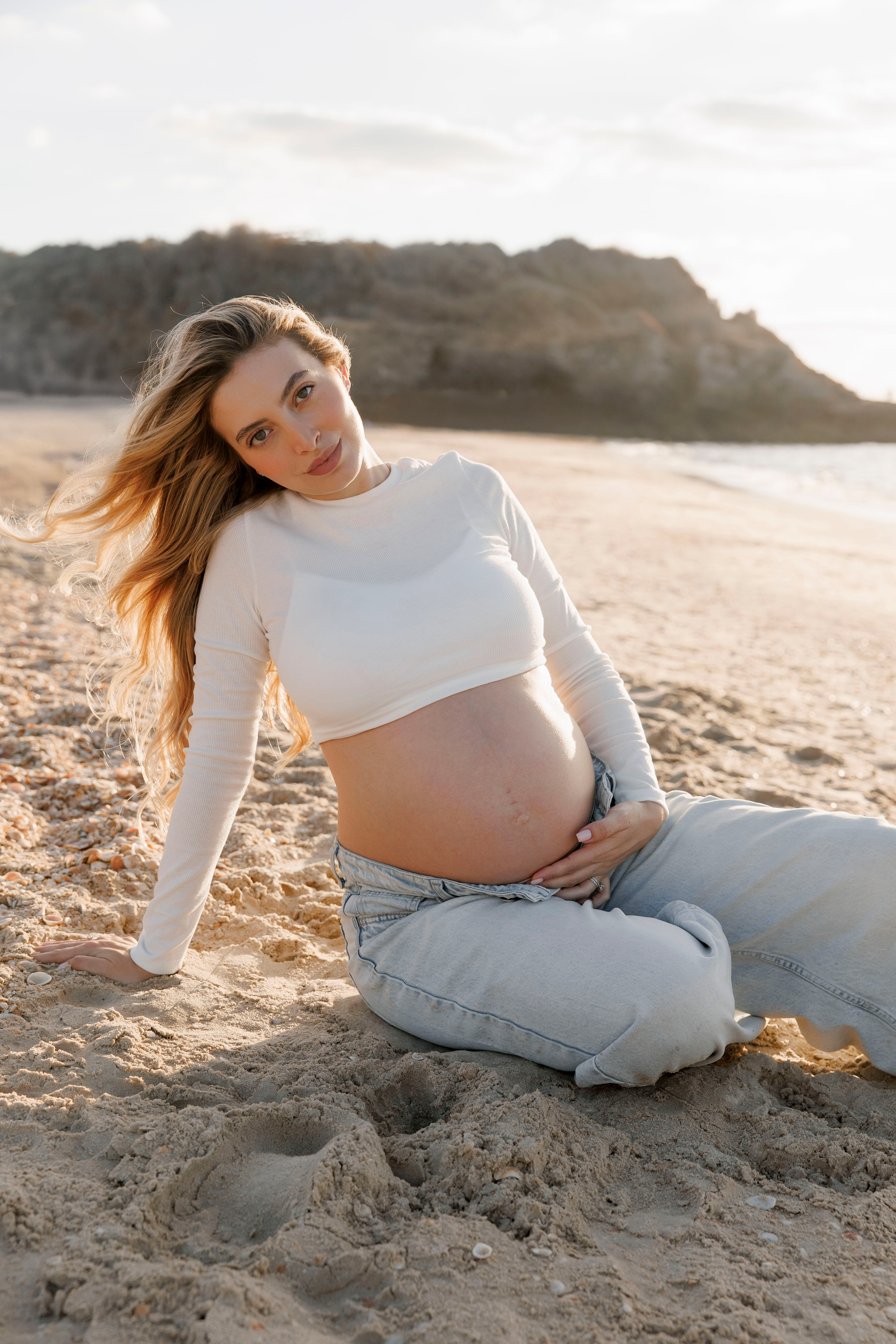 Pregnancy photoshoot near the sea. Wedding and family photographer