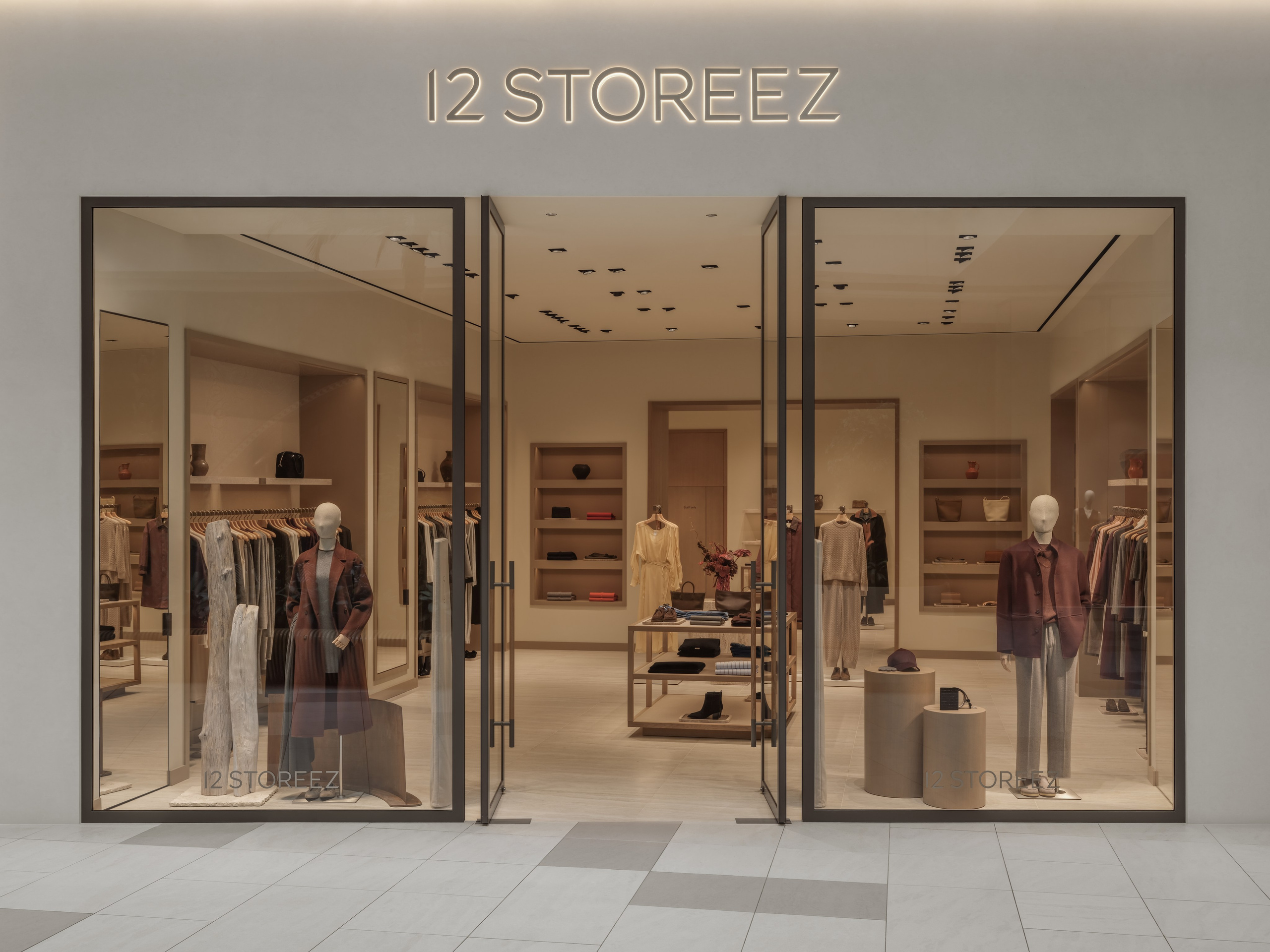 Wide interior view of the 12 STOREEZ clothing boutique in Astana, highlighting contemporary retail architecture, premium materials and curated product displays.