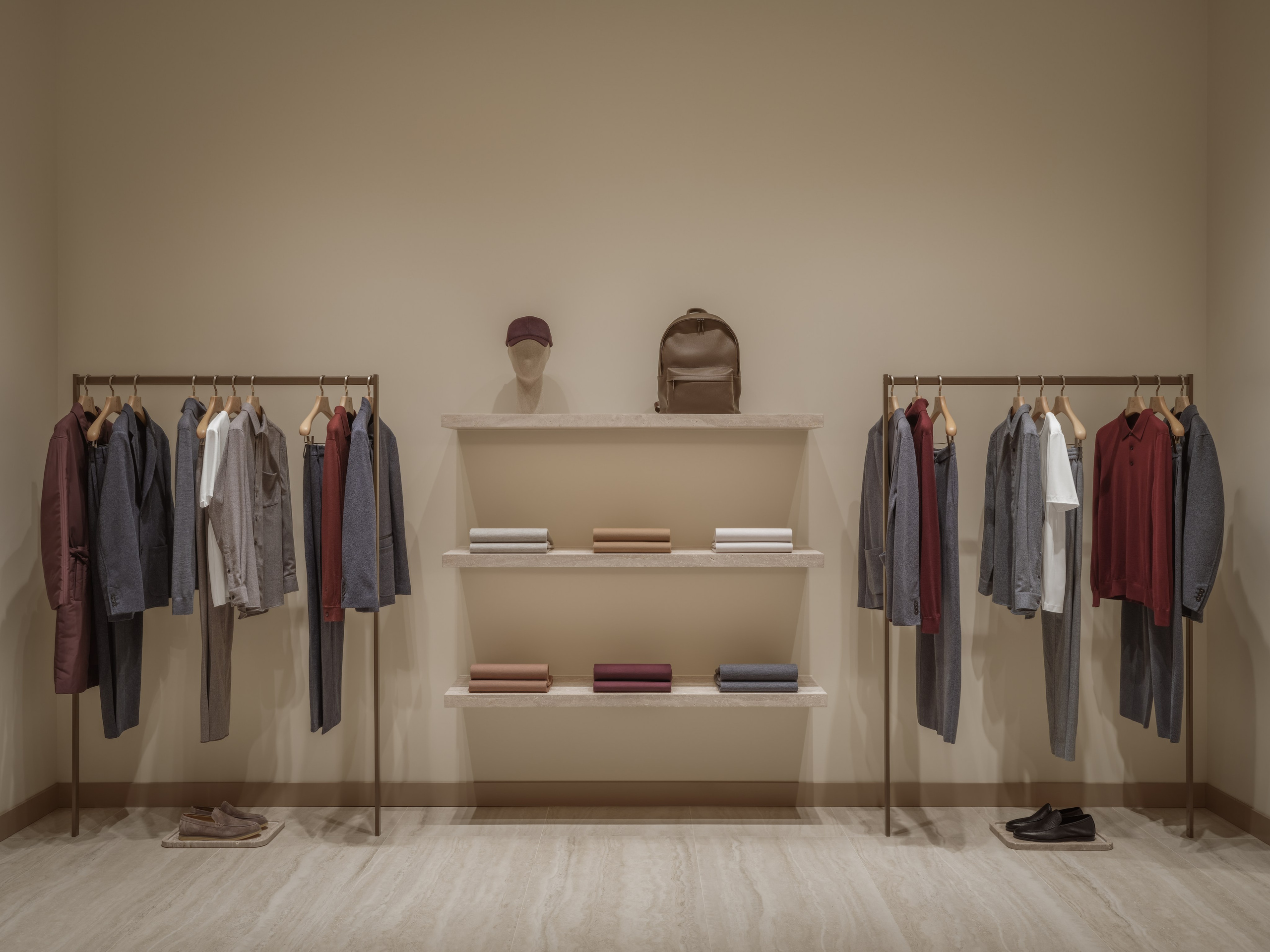 Luxury retail display with shelving, accessories and folded garments inside the 12 STOREEZ fashion boutique in Astana, captured with an architectural photography approach.