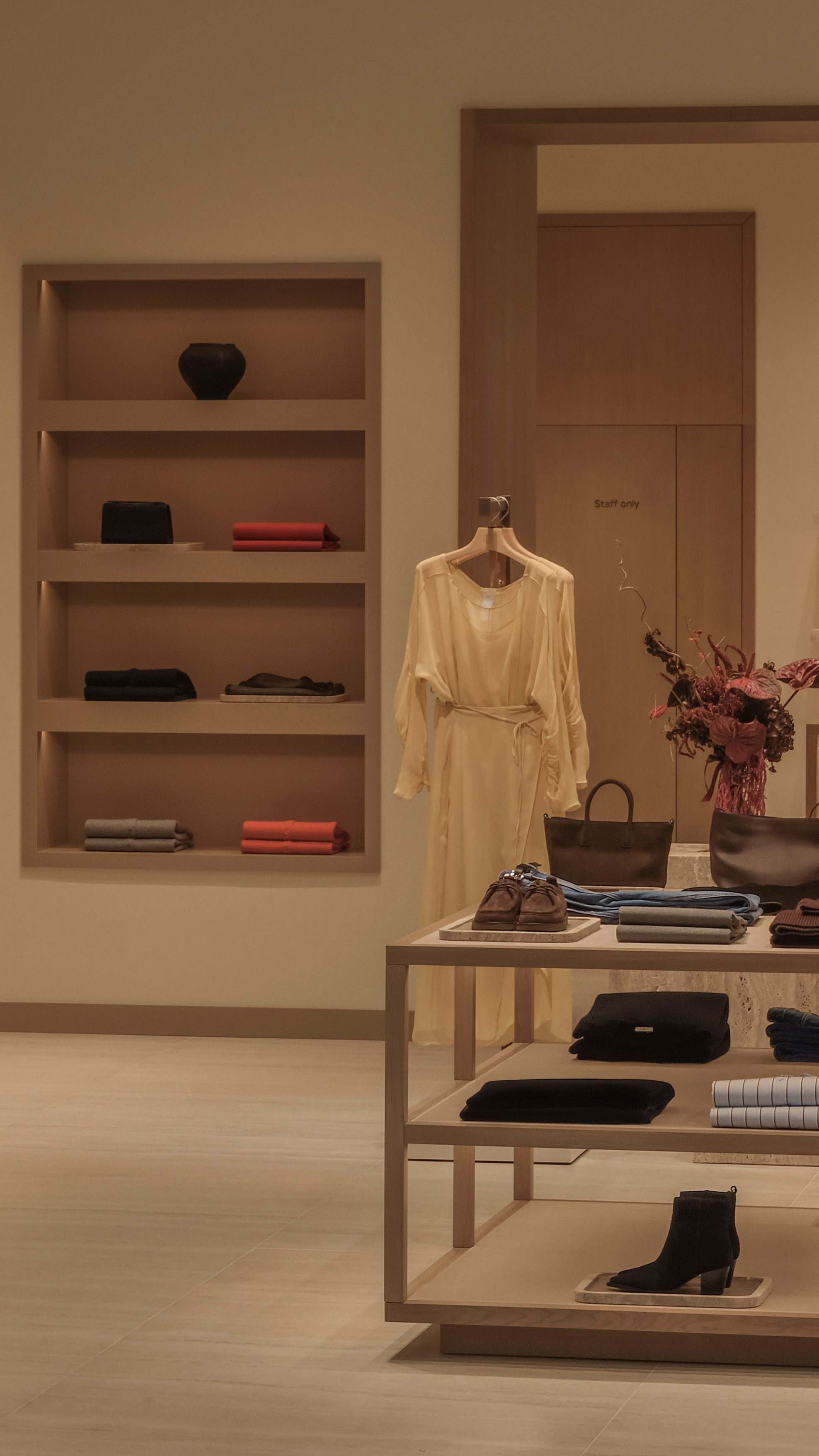 Interior detail of the 12 STOREEZ boutique featuring curated fashion displays, natural materials and minimalist retail interior design.