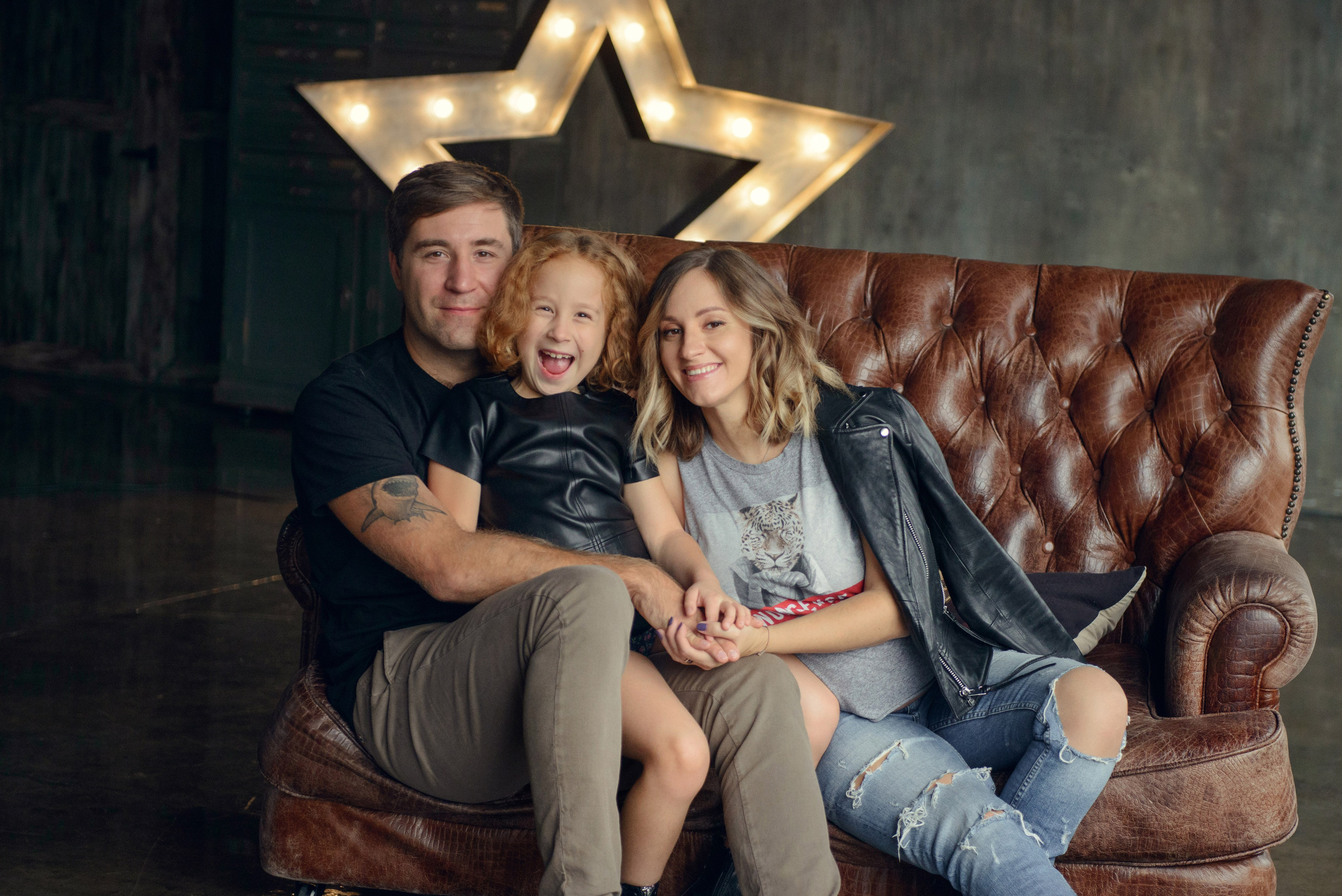 Family photo shoot with a pregnant woman in a loft studio, rock and roll style
