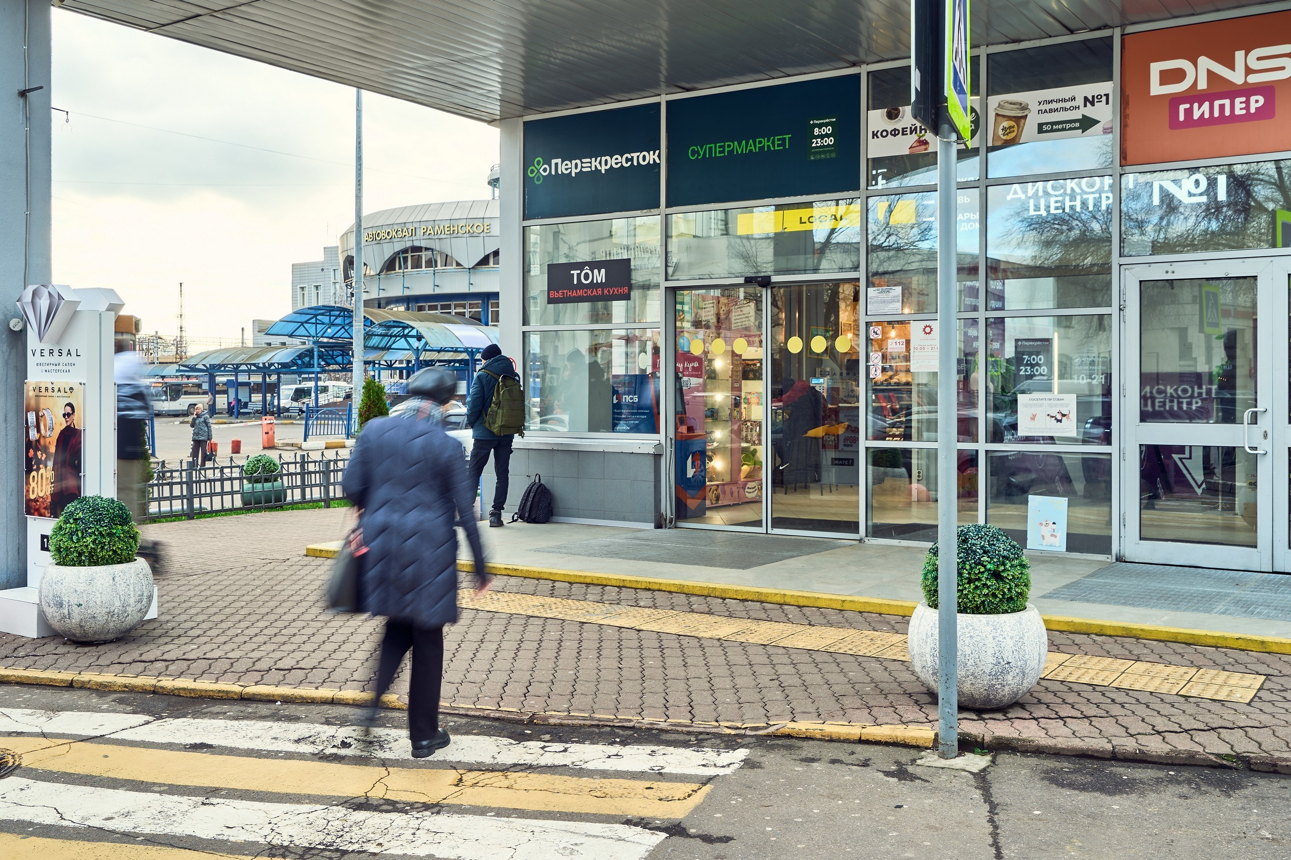 Архитектурная фотография входа в ТЦ "Солнечный" в Раменском со зданием автовокзала на заднем плане