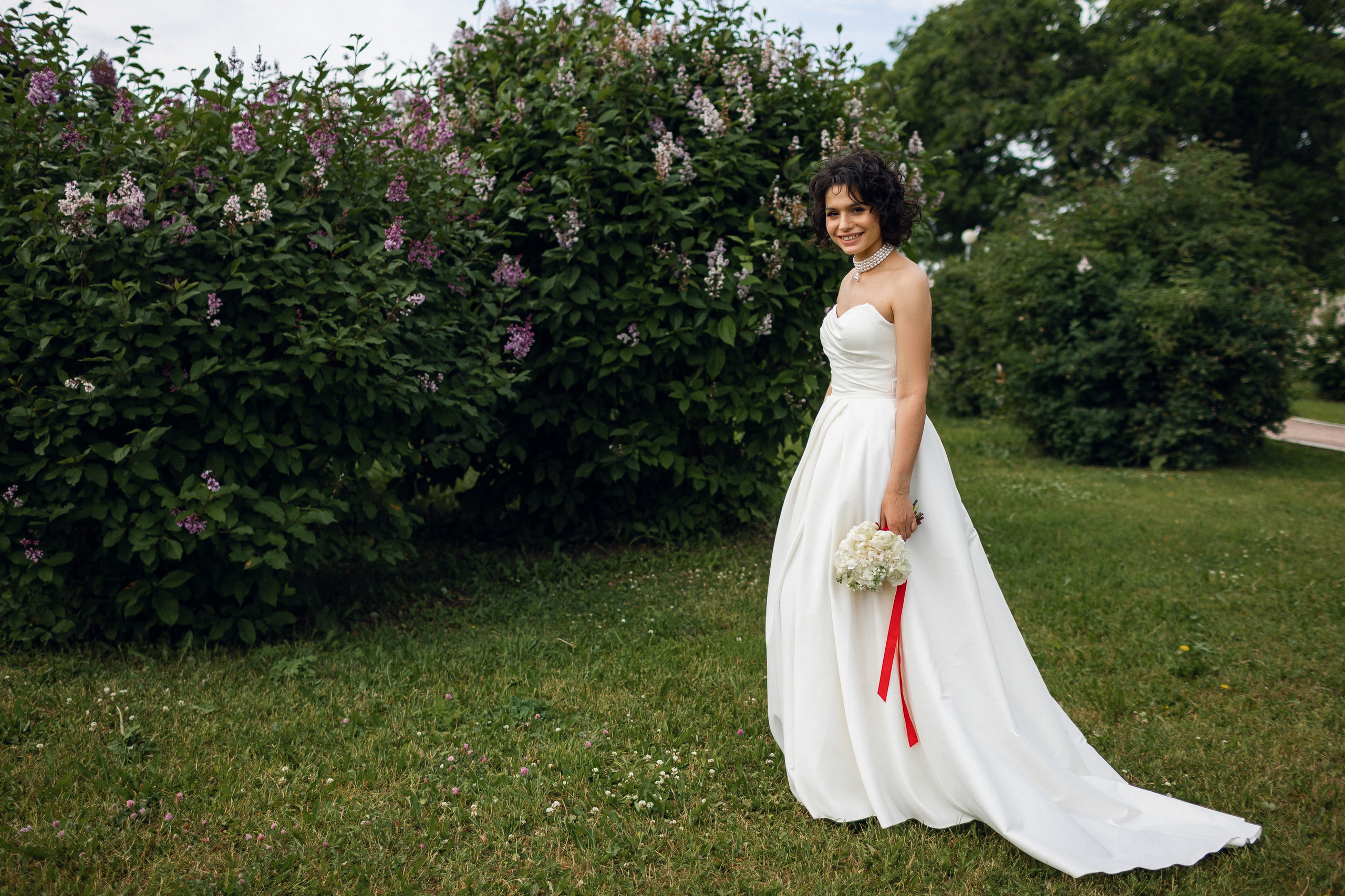 Летняя фотосессия в Архангельске: невеста с букетом у кустов сирени — работа Алексея Клещинова в стиле естественной эстетики