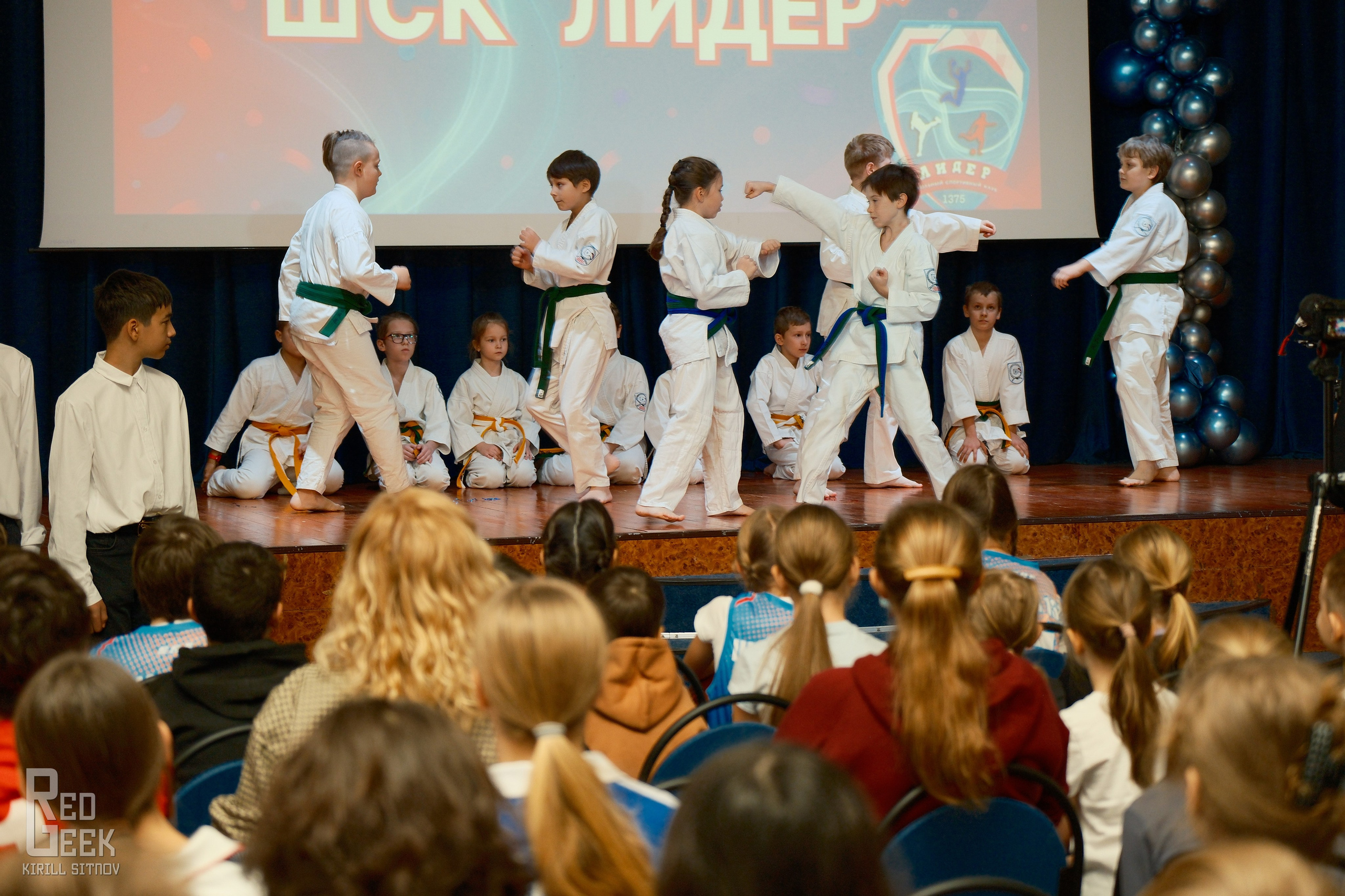 Дети из секции карате киокушинкай показывают ката в актовом зале.