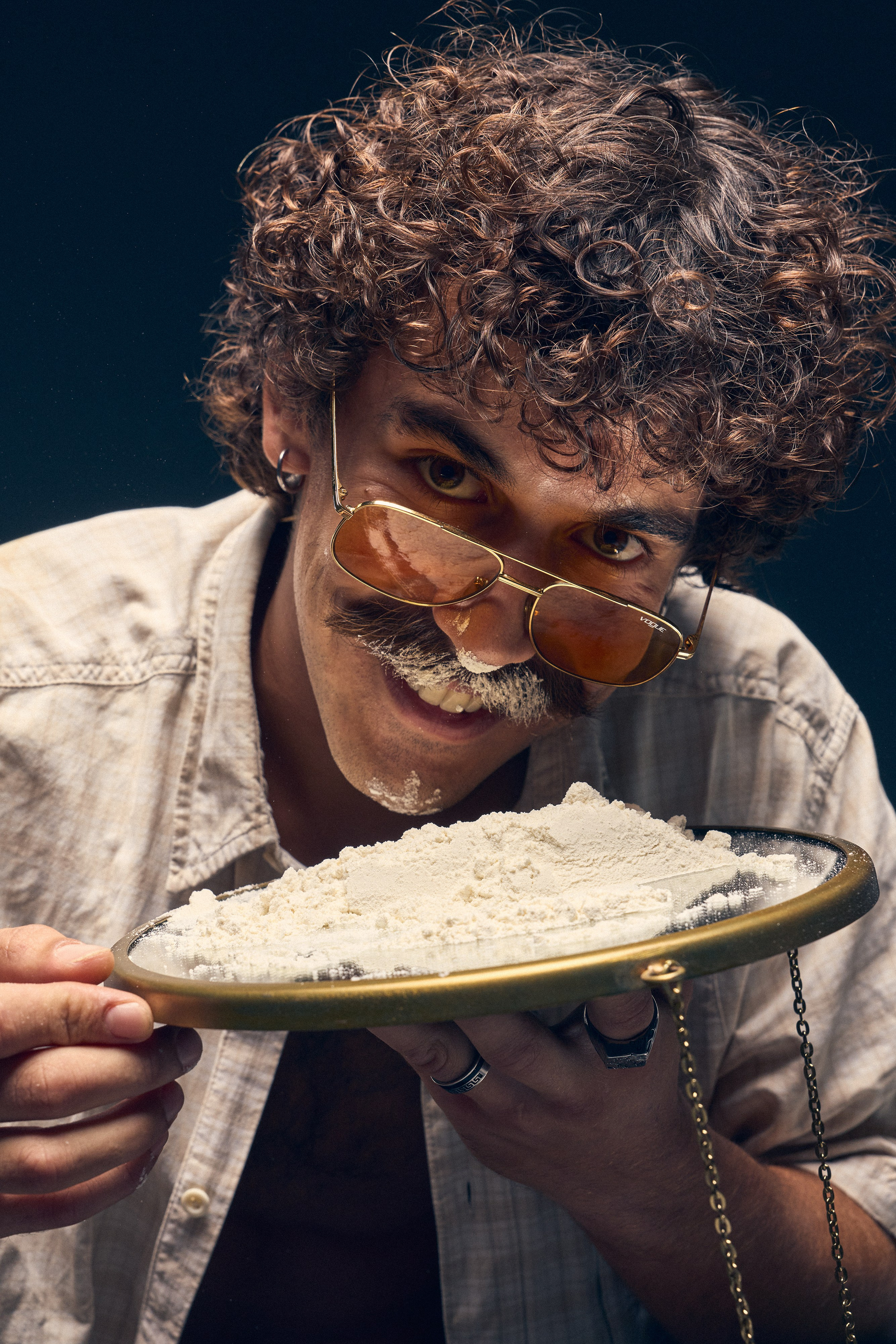 Vintage mood portrait of man sitting in dark studio