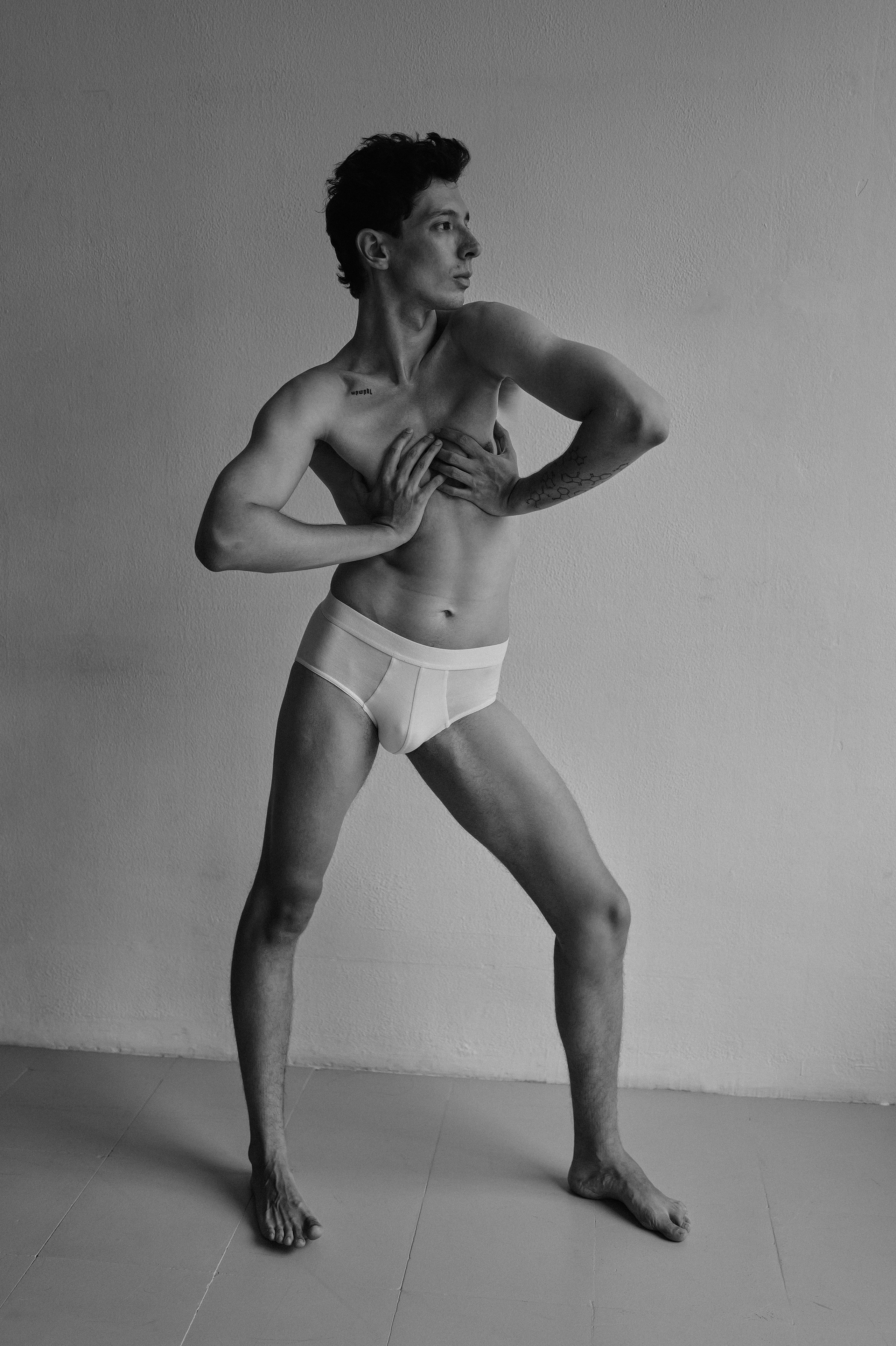 Black and white male model showing contortion pose in Barcelona art studio