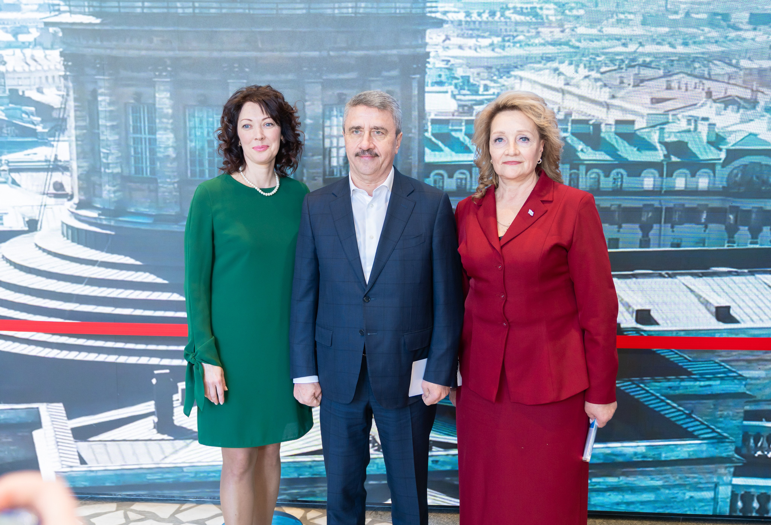 Группа участников Дня местного самоуправления Санкт-Петербурга на фоне большой панорамы города. Официальное мероприятие 2026 года. Фотография Евгения Мальцева.