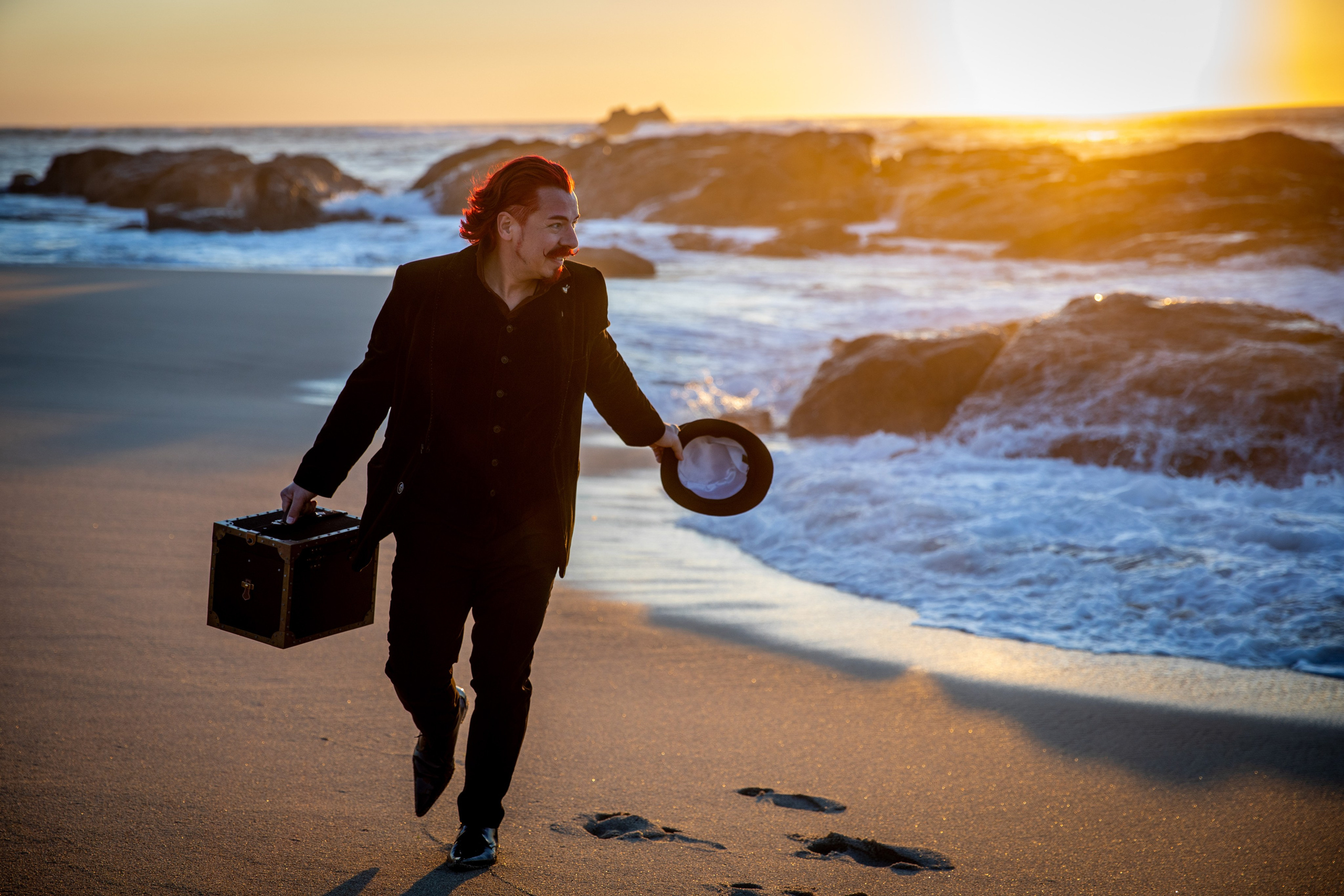Illusionist and magician walks on the beach and shows tricks